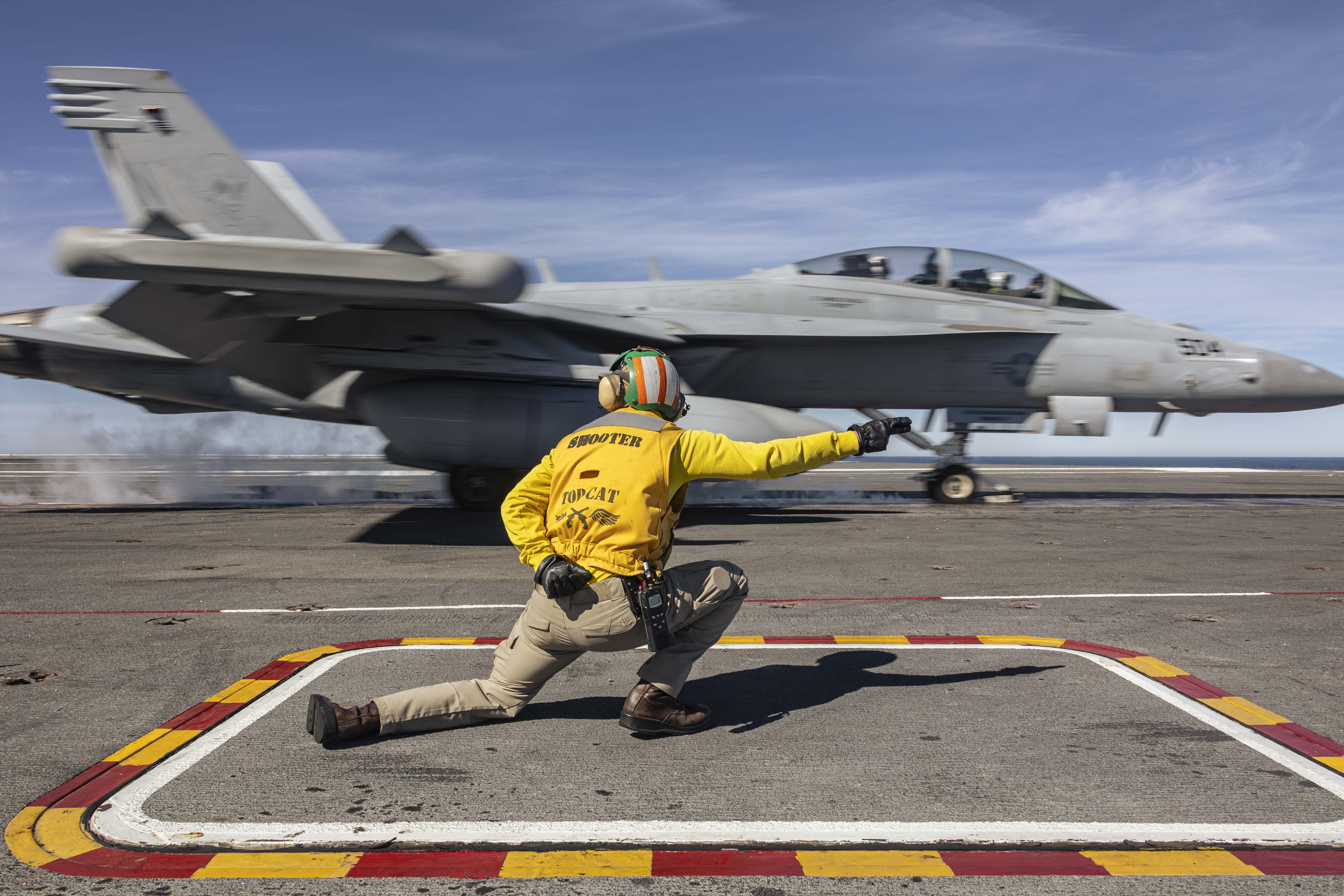 240127-N-LM220-1492 PACIFIC OCEAN (Jan. 27, 2024) Lt. Cmdr. Sean Smith, from Charlotte, N.C., shoots an EA-18G Growler, assigned to Electronic Attack Squadron (VAQ) 133, from the flight deck of the Nimitz-class aircraft carrier USS Abraham Lincoln (CVN 72). The Abraham Lincoln Carrier Strike Group is underway in the U.S. 3rd Fleet area of operations conducting advanced tactical training that increases warfighting capability and tactical proficiency across all domains. (U.S. Navy photo by Mass Communication Specialist 2nd Class Clayton A. Wren)