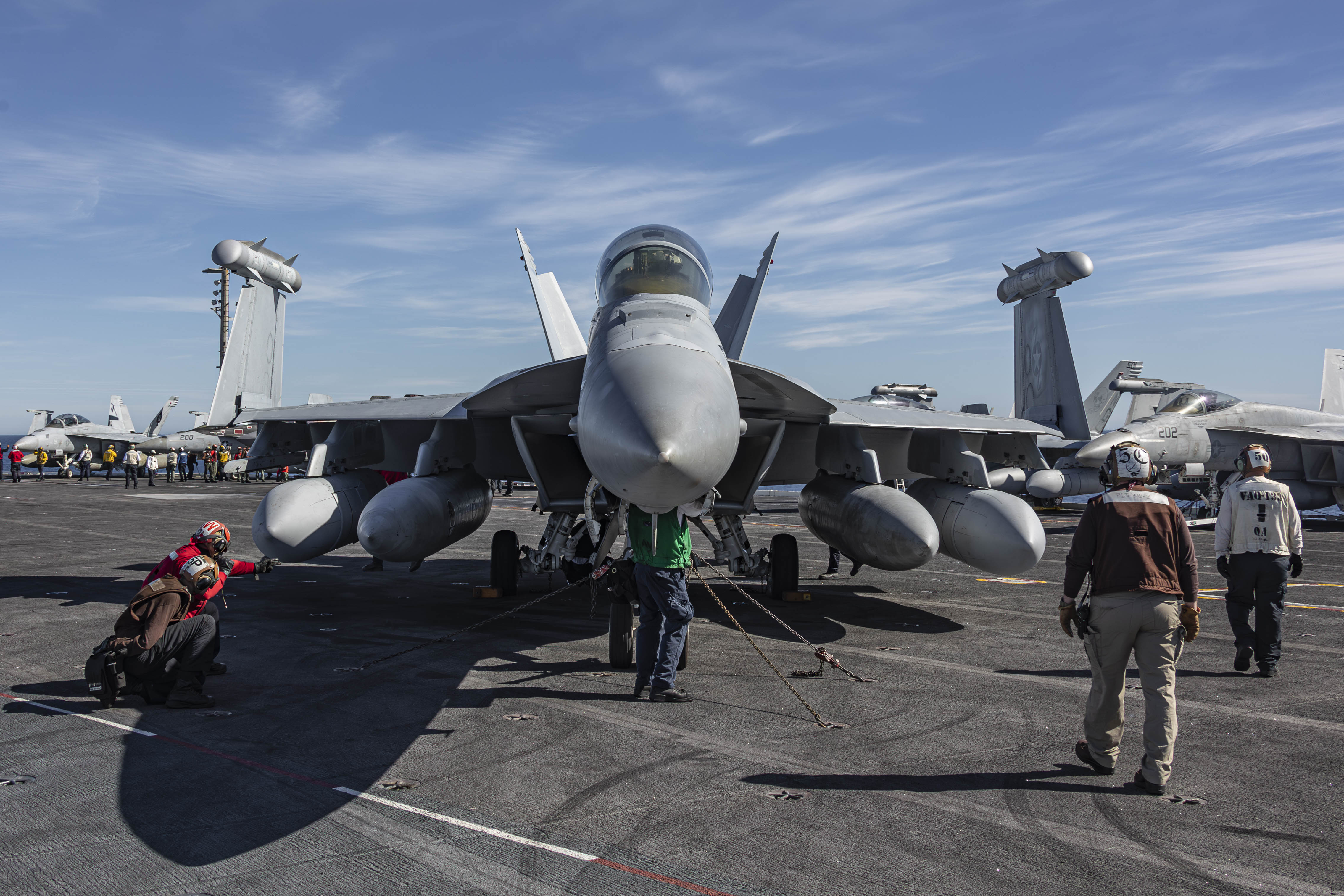 240127-N-LM220-1221 PACIFIC OCEAN (Jan. 27, 2024) Sailors remove chocks and chains from an EA-18G Growler, assigned to Electronic Attack Squadron (VAQ) 133, on the flight deck of the Nimitz-class aircraft carrier USS Abraham Lincoln (CVN 72). The Abraham Lincoln Carrier Strike Group is underway in the U.S. 3rd Fleet area of operations conducting advanced tactical training that increases warfighting capability and tactical proficiency across all domains. (U.S. Navy photo by Mass Communication Specialist 2nd Class Clayton A. Wren)