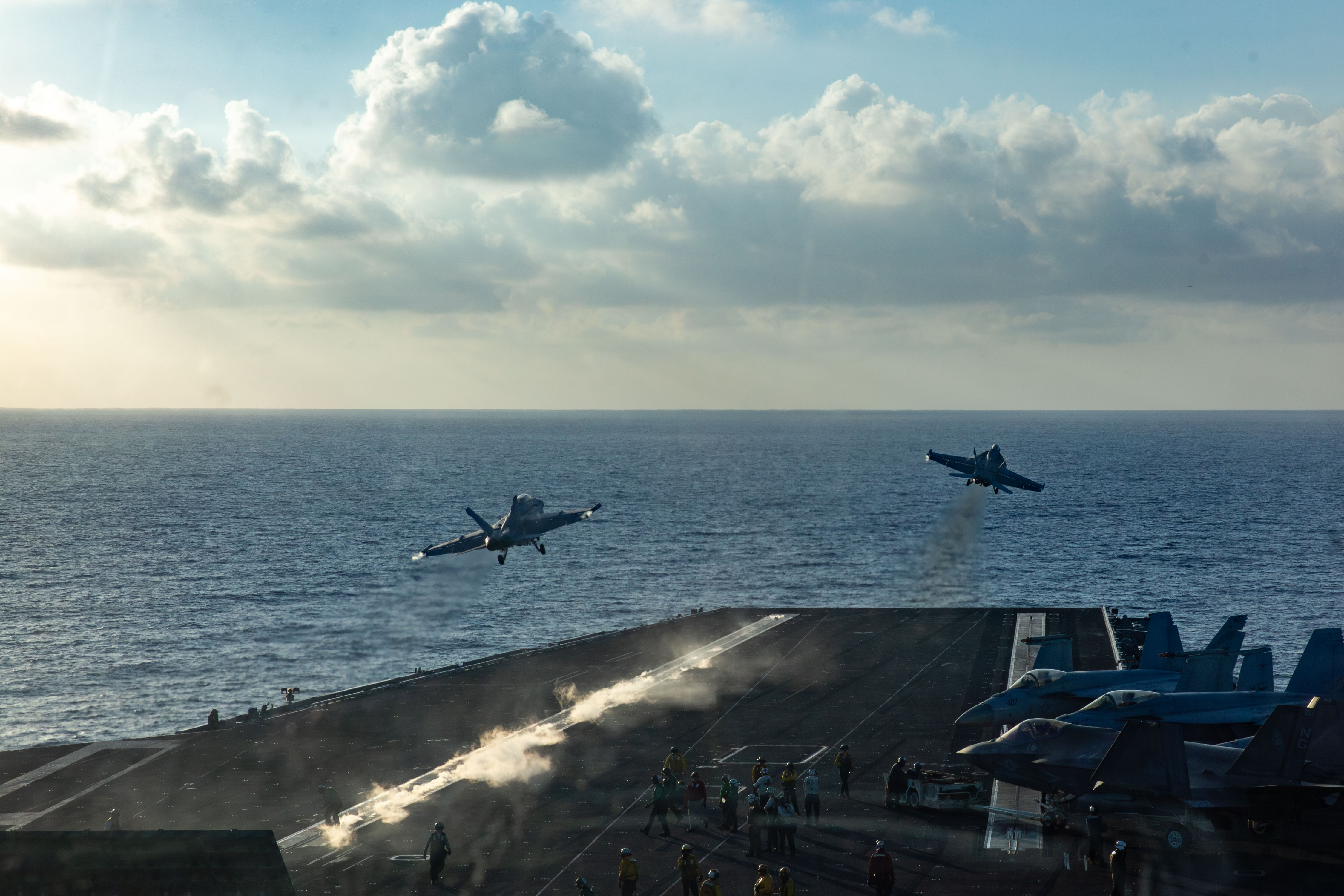 A Navy E/A-18G Growler, left, and a F/A-18E Super Hornet launch from the deck of the USS Abraham Lincoln in October during a deployment to the Middle East. (U.S. Navy)
