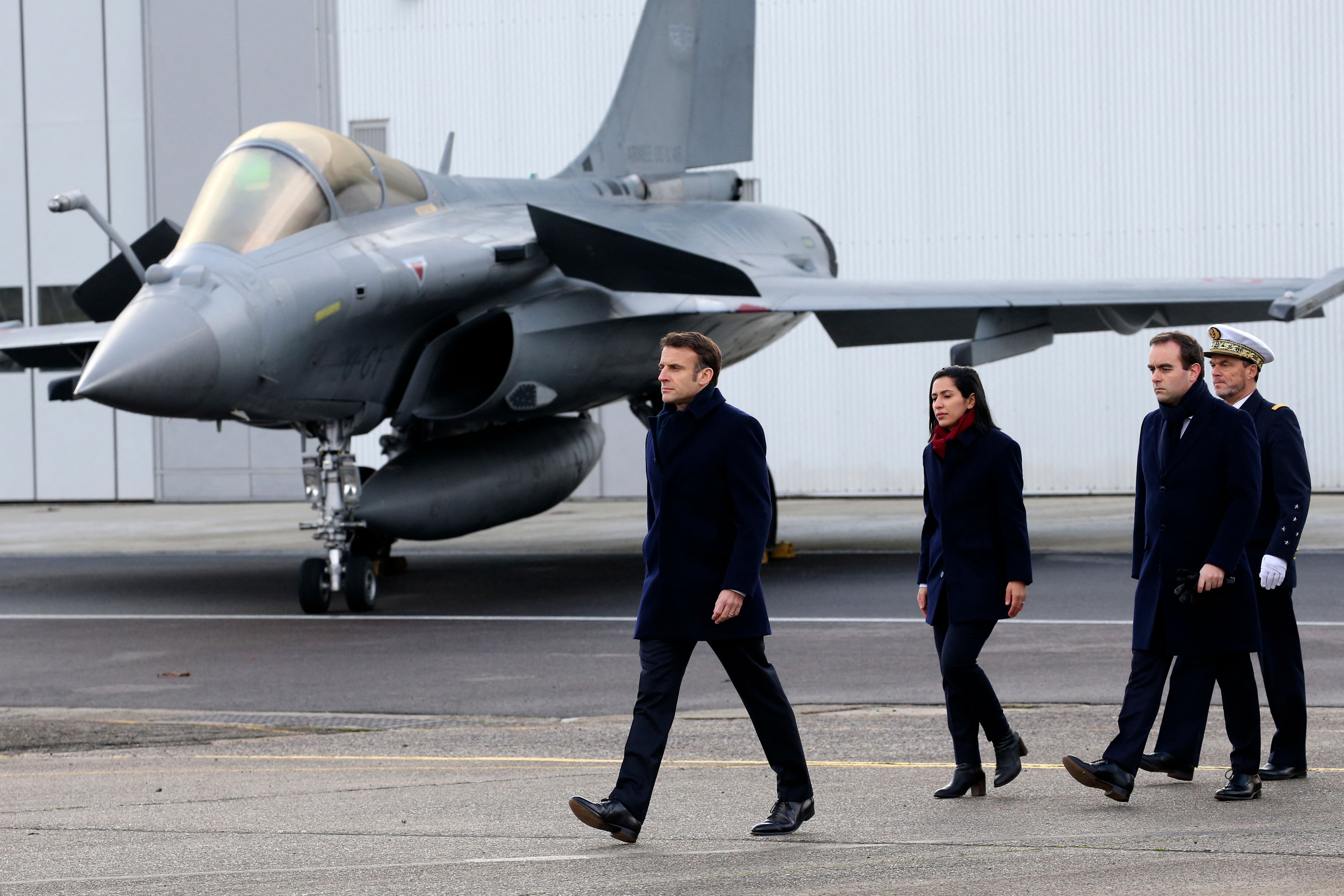 French President Emmanuel Macron, followed by French Armies Minister Sebastien Lecornu (2nd R), walks past a Dassault Rafale fighter aircraft during his New Year address to the French Army at the Mont-de-Marsan air base, southwestern France, on January 20, 2023. (Photo by Bob Edme / POOL / AFP) (Photo by BOB EDME/POOL/AFP via Getty Images)