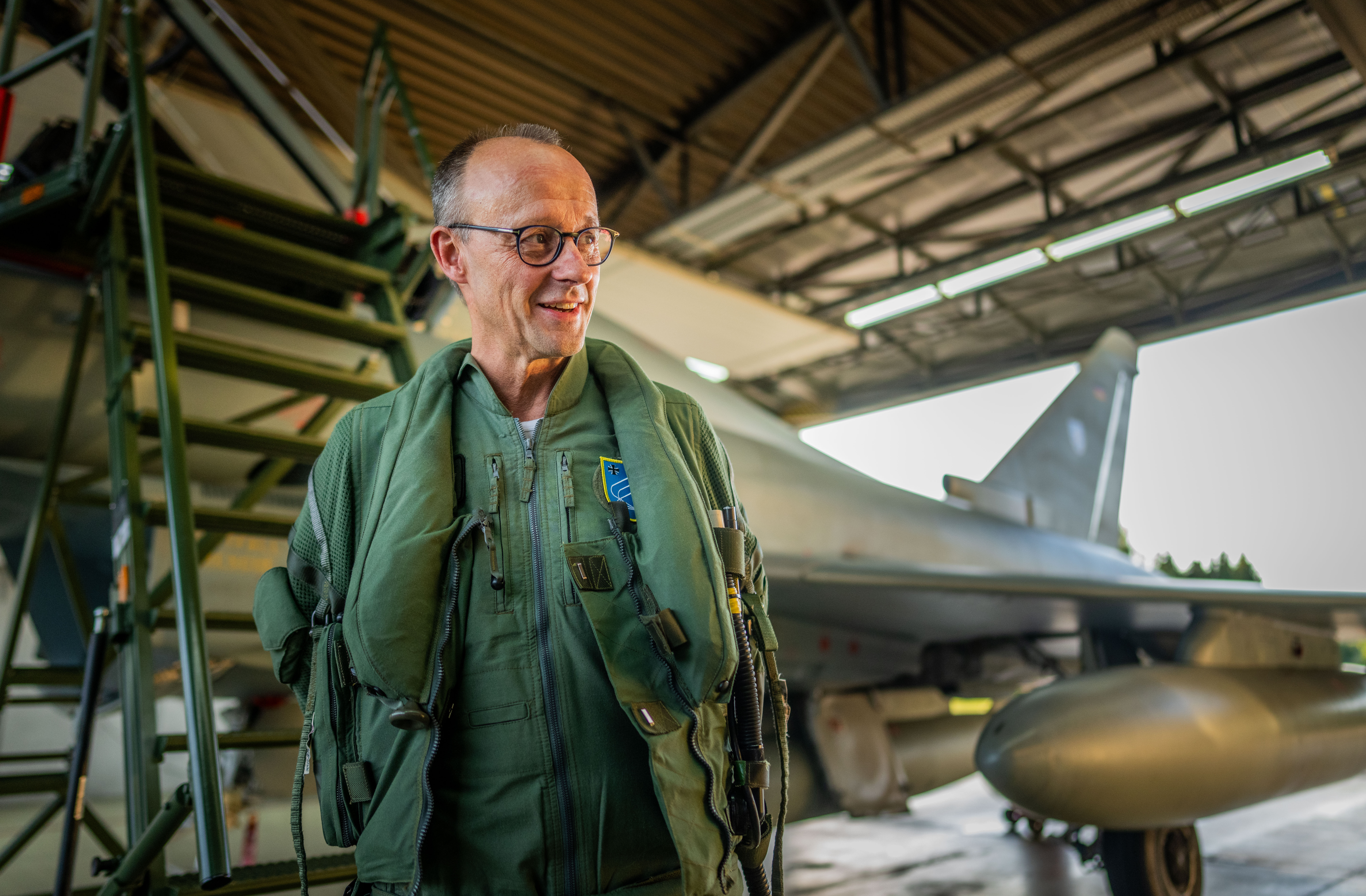 20 June 2024, Mecklenburg-Western Pomerania, Rostock-Laage: Friedrich Merz, CDU Federal Chairman and CDU/CSU parliamentary group leader in the Bundestag, stands in front of a Bundeswehr Eurofighter. Merz flew as a "passenger" in a two-seater Eurofighter of the "Tactical Air Force Wing 73" to find out about the work of the air force. Photo: Michael Kappeler/dpa (Photo by Michael Kappeler/picture alliance via Getty Images)
