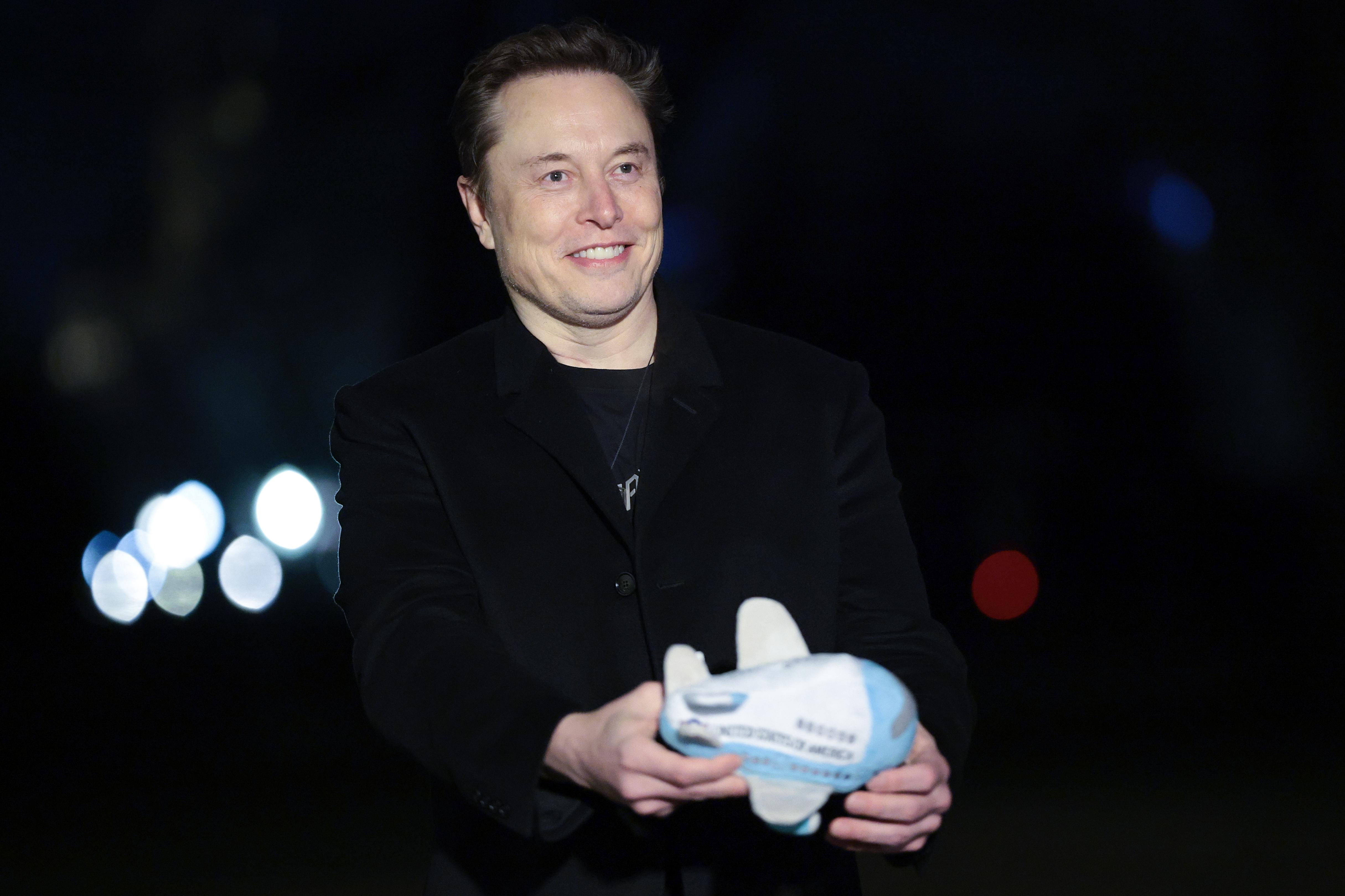 WASHINGTON, DC - FEBRUARY 19: Tesla and SpaceX CEO Elon Musk holds up an Air Force One stuffed toy as he walks from the presidential helicopter Marine One on the South Lawn of the White House on February 19, 2025 in Washington, DC. Musk accompanied U.S. President Donald Trump who was returning to the White House. (Photo by Win McNamee/Getty Images)