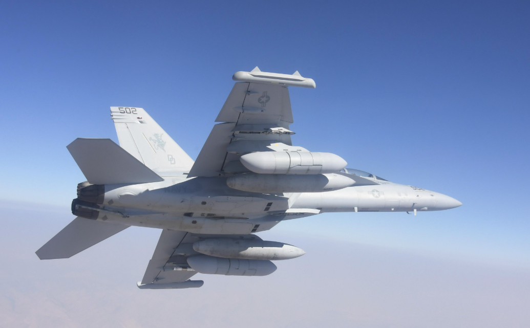 The AN/ALQ-249 Next Generation Jammer is seen under the wing of an E/A-18G Growler. (U.S. Navy)