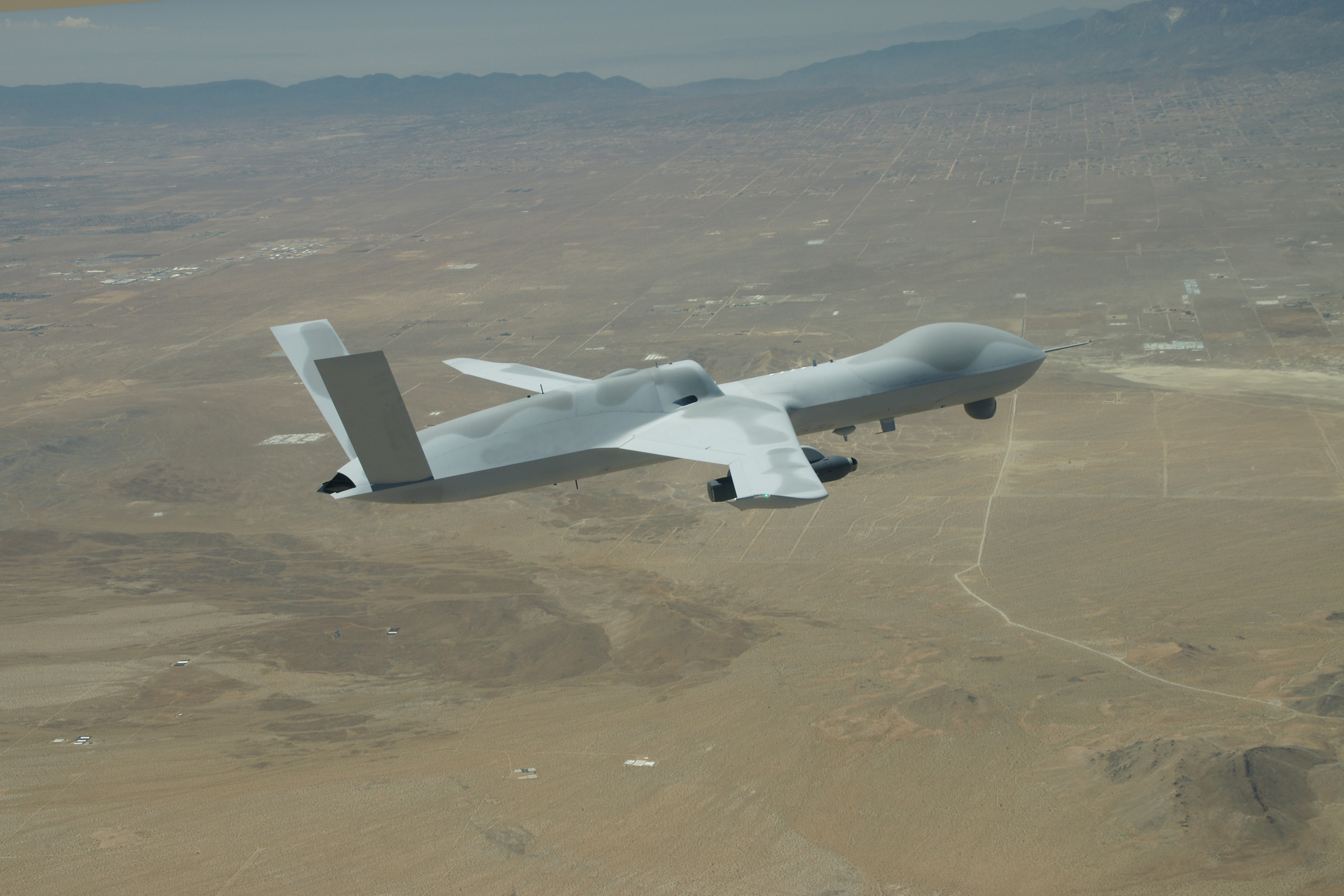 A General Atomics MQ-20 Avenger unmanned vehicle returns to El Mirage Airfield, Calif. June 24, 2021. The MQ-20 successfully participated in Edwards Air Force Base’s Orange Flag 21-2 to test the Skyborg Autonomy Core System. (Photo courtesy of General Atomics)(This photo was edited by blurring the tail number for security purposes.)