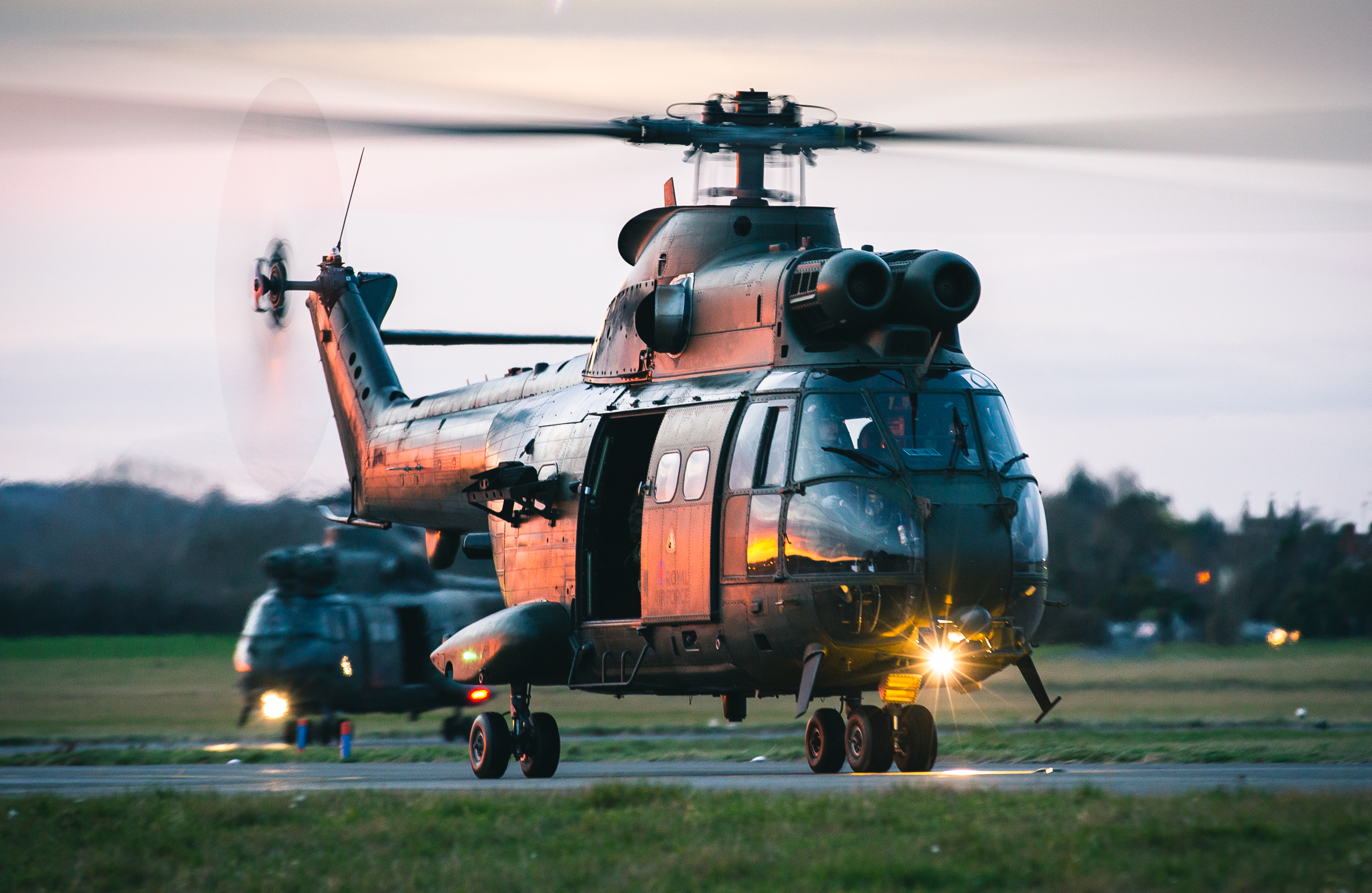 'Orange Glow'-Two Puma 2 medium lift helicopters return home to RAF Benson after a long day supporting Exercise Wessex Storm, moving troops from 2 Para on 4 Dec 2020. The glow from the sunset reflects off the side of the aircraft to create a unique light as they taxi back.