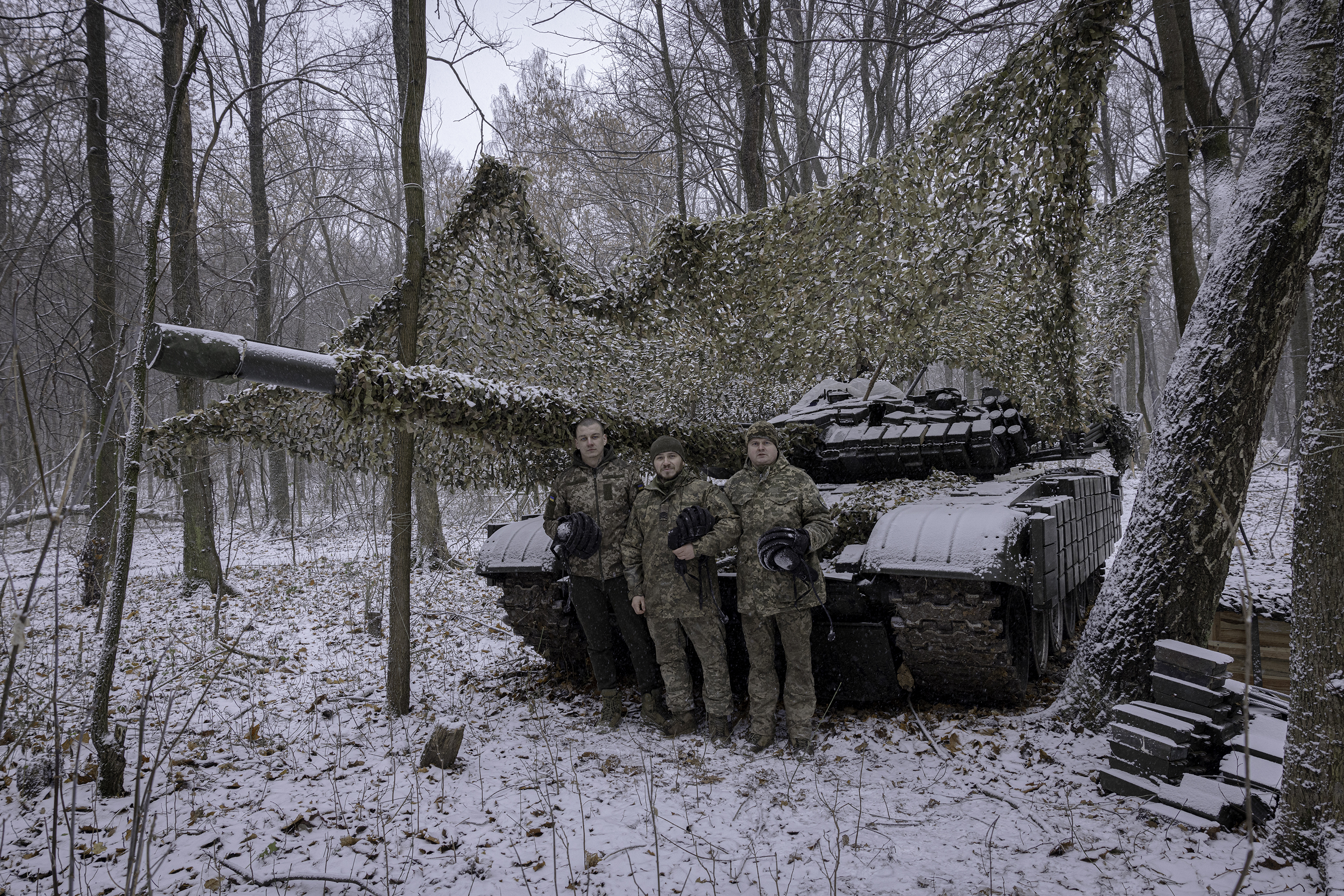 SUMY REGION, UKRAINE - DECEMBER 6, 2024: Tank commander Nazar, 23, stands with fellow soldiers Ruslan, 35, and Andrii, 37, at a fallback position in Sumy region, Ukraine. The troops, from Ukraine's 95th Brigade, were preparing for orders to return to Russia's Kursk region. (Photo by Serhiy Morgunov/For The Washington Post via Getty Images)
