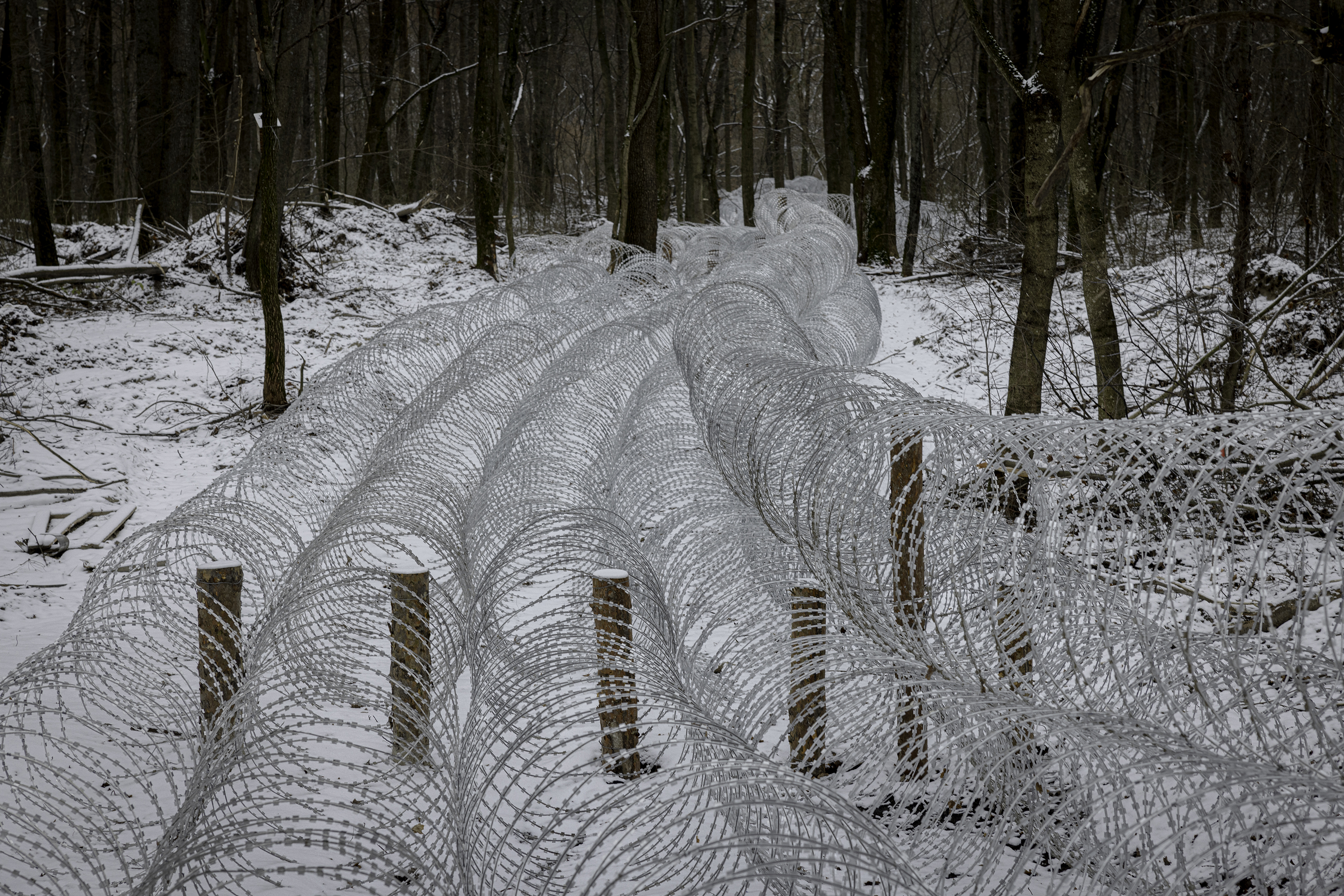SUMY REGION, UKRAINE - DECEMBER 8, 2024: Ukrainian troops have installed defenses such as this barbed wire across many key routes within Sumy region, to protect against a potential Russian counterassault. Past Ukrainian failures to properly reinforce defenses have caused troop and territorial losses. (Photo by Serhiy Morgunov/For The Washington Post via Getty Images)