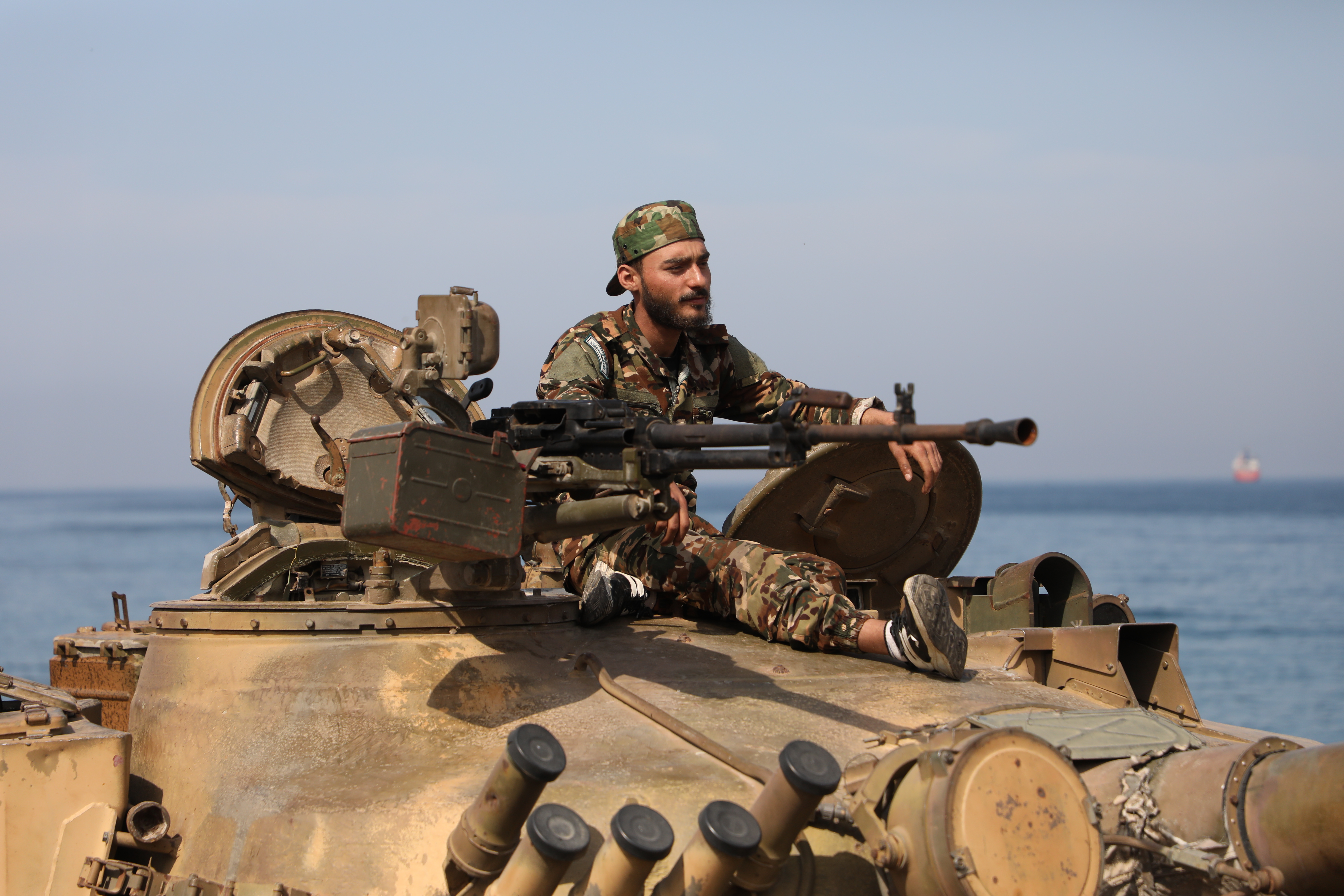 BANIYAS, SYRIA - MARCH 7: A fighters with the new Syrian government rides on a tank on March 7, 2025 in Baniyas, Syria. Dozens of people have been killed in clashes between loyalists of the deposed Assad regime and forces of the country's new rulers. It is the heaviest such fighting since Syrian rebels toppled the Assad regime last December. (Photo by Ali Haj Suleiman/Getty Images)