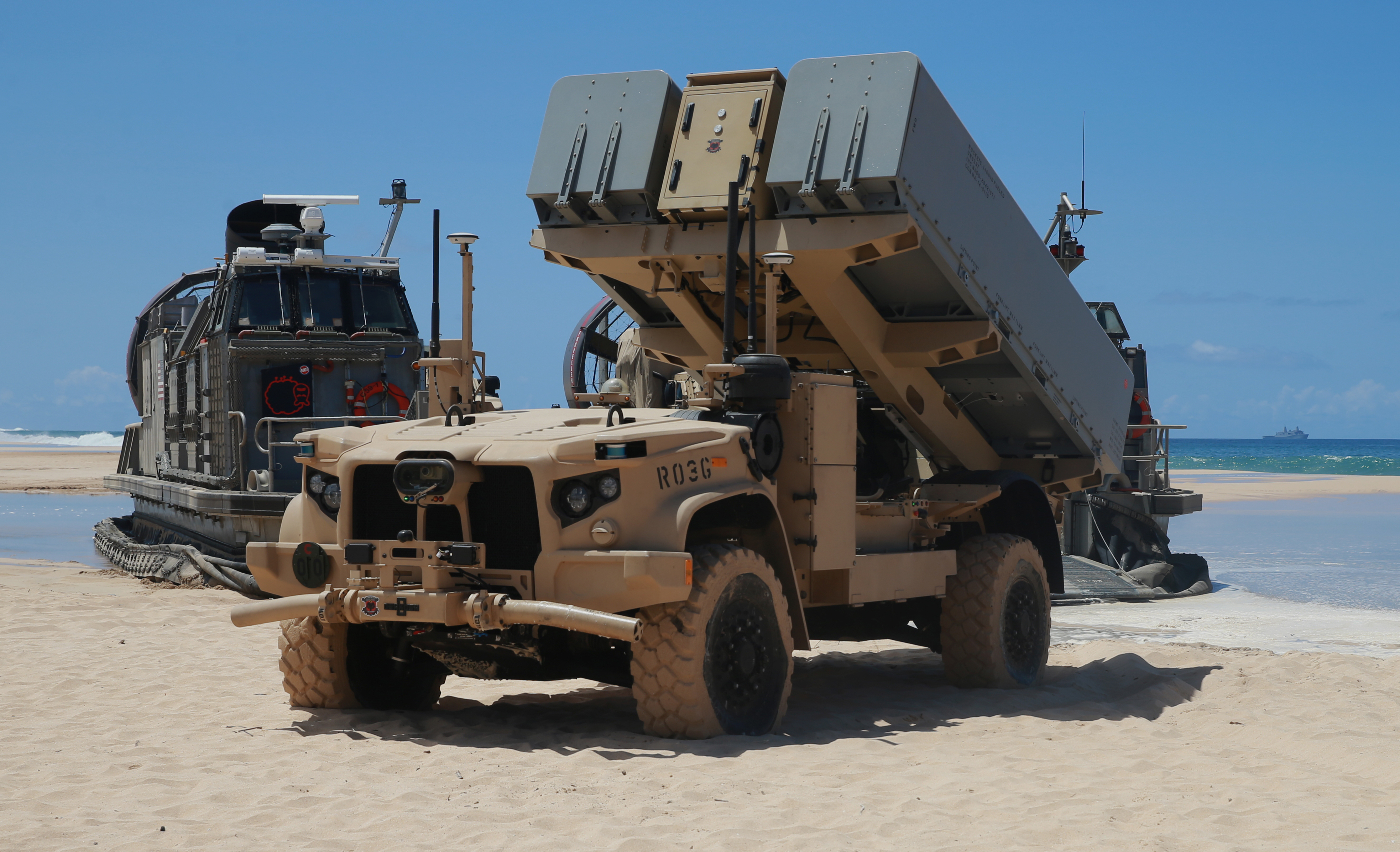 A Navy Marine Expeditionary Ship Interdiction System launcher deploys into position aboard Pacific Missile Range Facility Barking Sands, Hawaii, Aug. 16, 2021. The NMESIS and its Naval Strike Missiles participated in a live-fire exercise, here, part of Large Scale Exercise 2021. During the training, a Marine Corps fires expeditionary advanced base sensed, located, identified and struck a target ship at sea, which required more than 100 nautical miles of missile flight. The fires EAB Marines developed a targeting solution for a joint force of seapower and airpower which struck the ship as the Marines displaced to a new firing position. The Marine Corps EABO concept is a core component of the Force Design 2030 modernization effort. (U.S. Marine Corps photo by Maj. Nick Mannweiler, released)