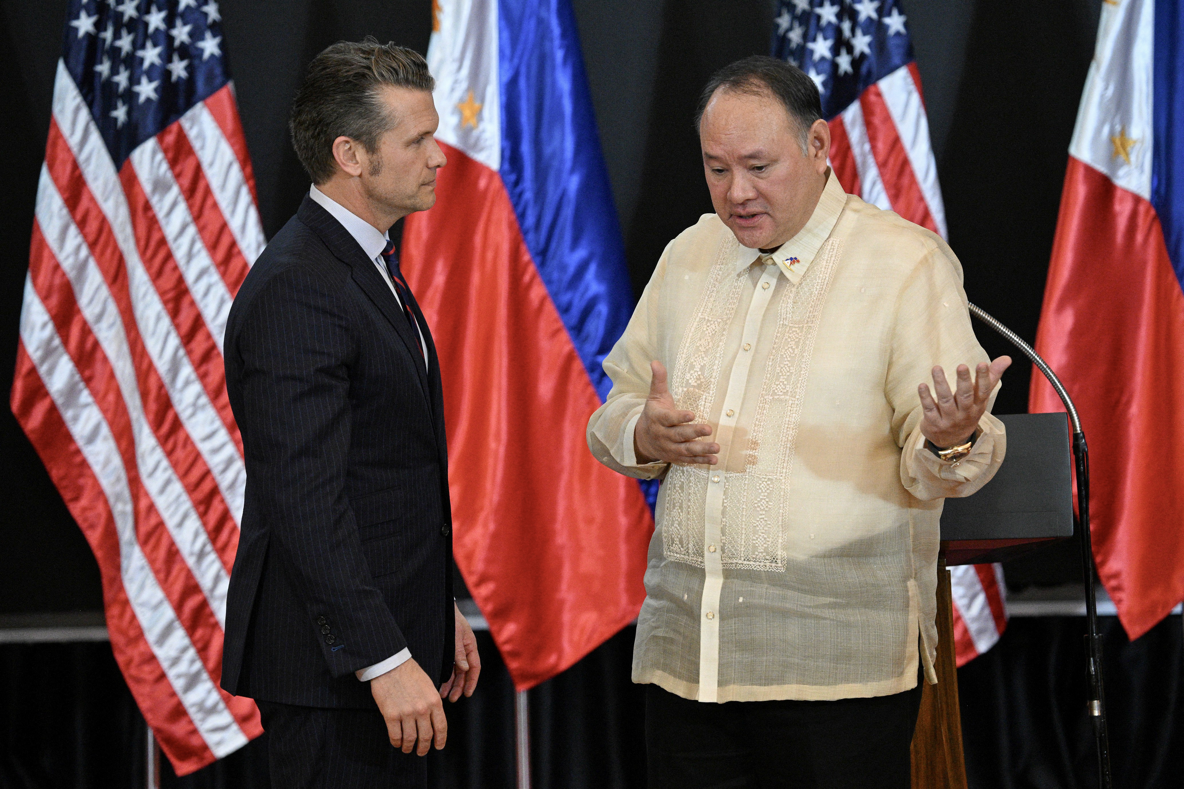 US Secretary of Defense Pete Hegseth (L) and Philippines' Secretary of National Defense Gilberto Teodoro speak after a joint press conference following their meeting at Camp Aguinaldo in Manila on March 28, 2025. US defense chief Pete Hegseth met Philippine President Ferdinand Marcos on March 28, saying the two countries must stand "shoulder to shoulder" in the face of the threat represented by China. (Photo by Ted ALJIBE / AFP) (Photo by TED ALJIBE/AFP via Getty Images)