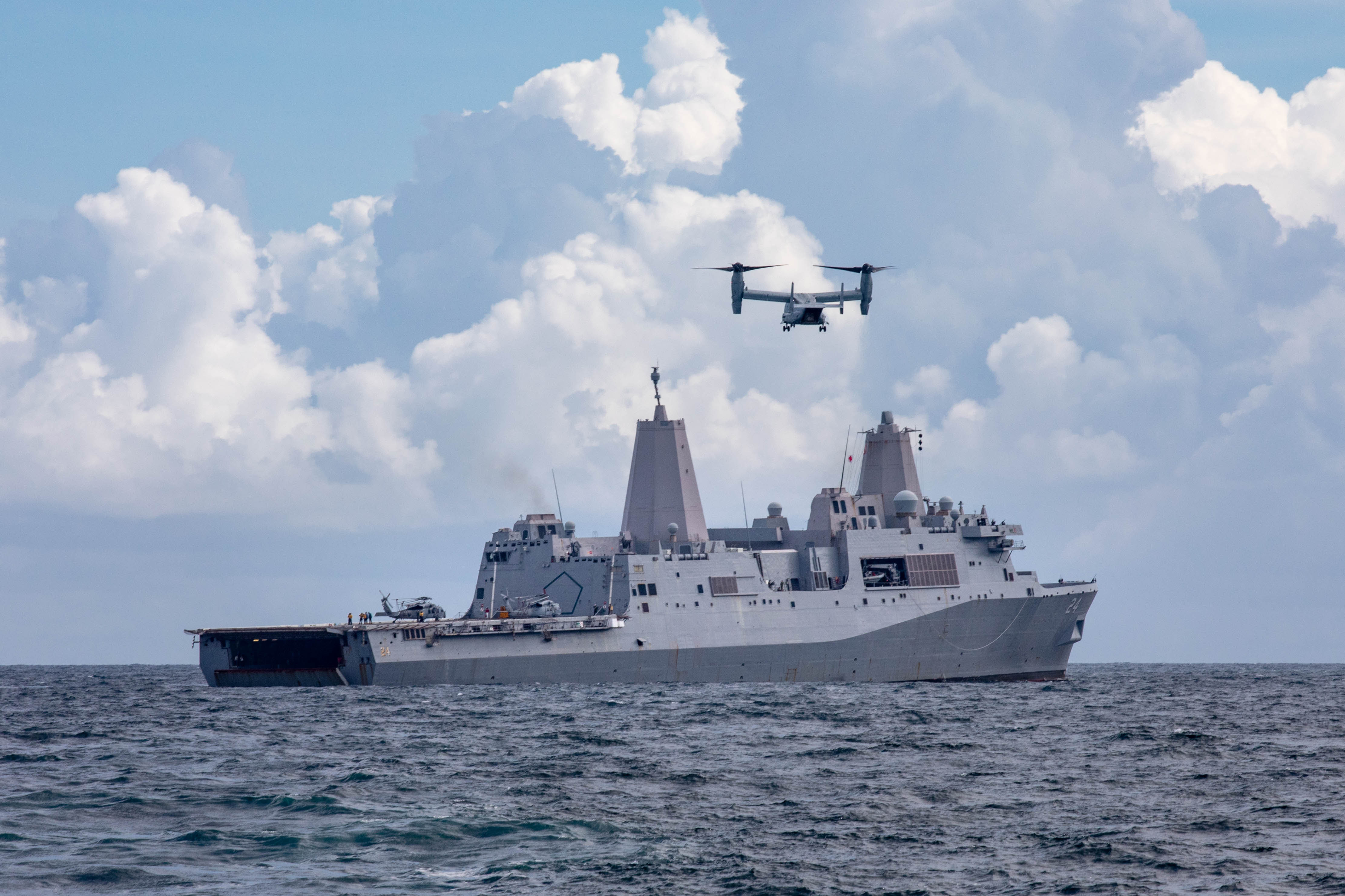 210818-N-PC065-1026 ATLANTIC OCEAN - (Aug. 18, 2021) -- An MV-22 Osprey transport aircraft assigned to the “Fighting Griffins” of Marine Medium Tiltrotor Squadron (VMM) 266 prepares to land on the San Antonio-class amphibious transport dock ship USS Arlington (LPD 24) to deliver supplies in support of the ship’s mission to Haiti, Aug. 18, 2021. Arlington is deployed to U.S Naval Forces Southern Command/U.S. 4th Fleet to support humanitarian assistance and disaster relief (HADR) efforts in Haiti following a 7.2-magnitude earthquake Aug. 14, 2021. (U.S. Navy photo by Mass Communication Specialist 2nd Class John Bellino/Released)
