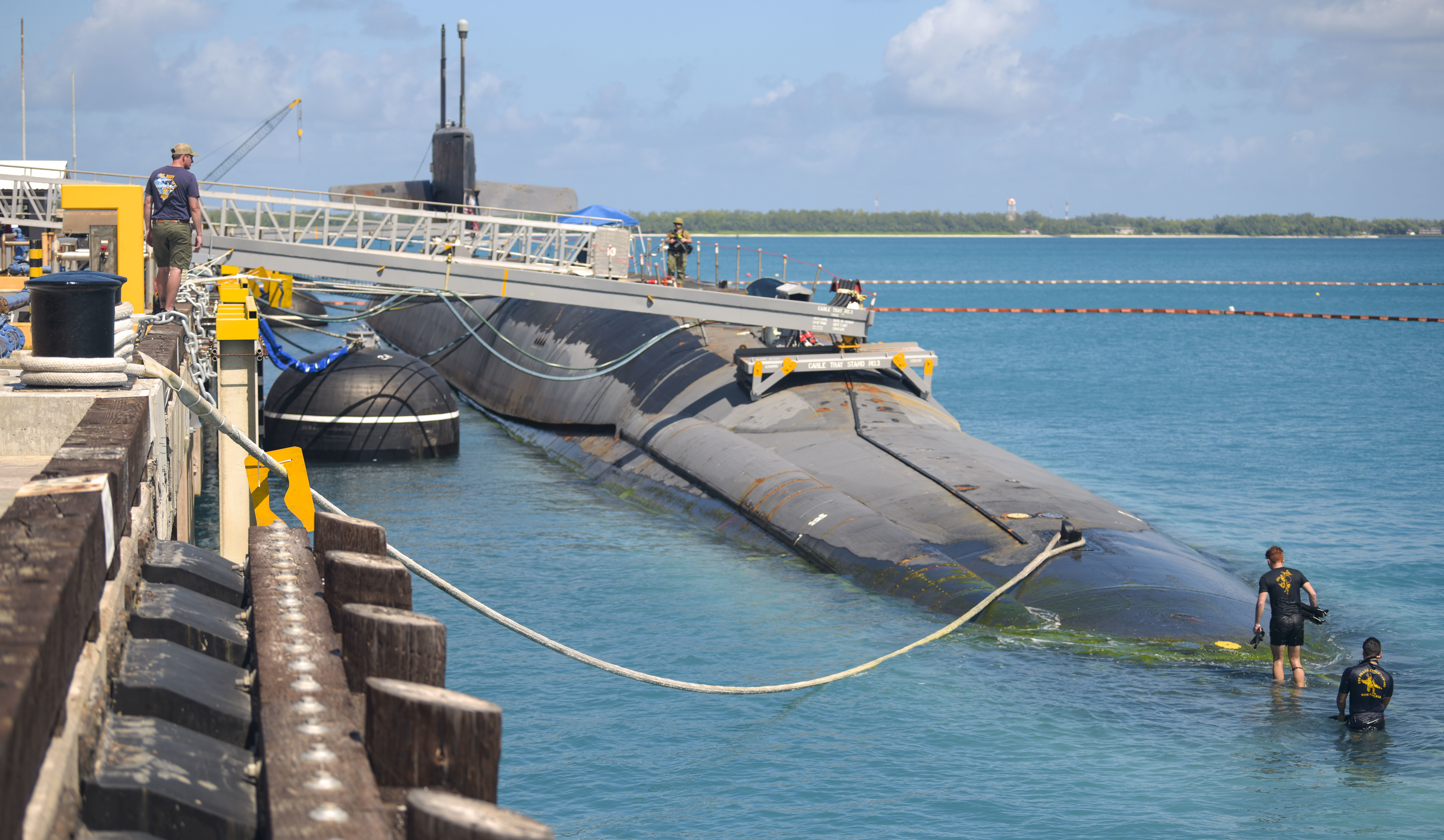 221030-N-EJ241-1240 DIEGO GARCIA, British Indian Ocean Territory (Oct. 30, 2022) – Navy Diver 2nd Class Jaden Johns, right, and Navy Diver 2nd Class Gabriel Gaona, both assigned to submarine tender USS Emory S. Land (AS 39) exit the water after an Anti-terrorism Force Protection Security Swim during the Ohio-class ballistic-missile submarine USS West Virginia (SSBN-736) port visit at U.S. Navy Support Facility (NSF) Diego Garcia. This port visit to Diego Garcia reflects the United States’ commitment to the Indo-Pacific region, and complements the many exercises, training, operations, and the other military cooperation activities conducted by Strategic Forces to ensure they are available and ready to operate around the globe at any time. West Virginia is one of six ballistic-missile submarines stationed at Naval Submarine Base Kings Bay, Georgia, and is capable of carrying up to 20 submarine launched ballistic missiles with multiple warheads. (U.S. Navy photo by Mass Communication Specialist 2nd Class Jan David De Luna Mercado)