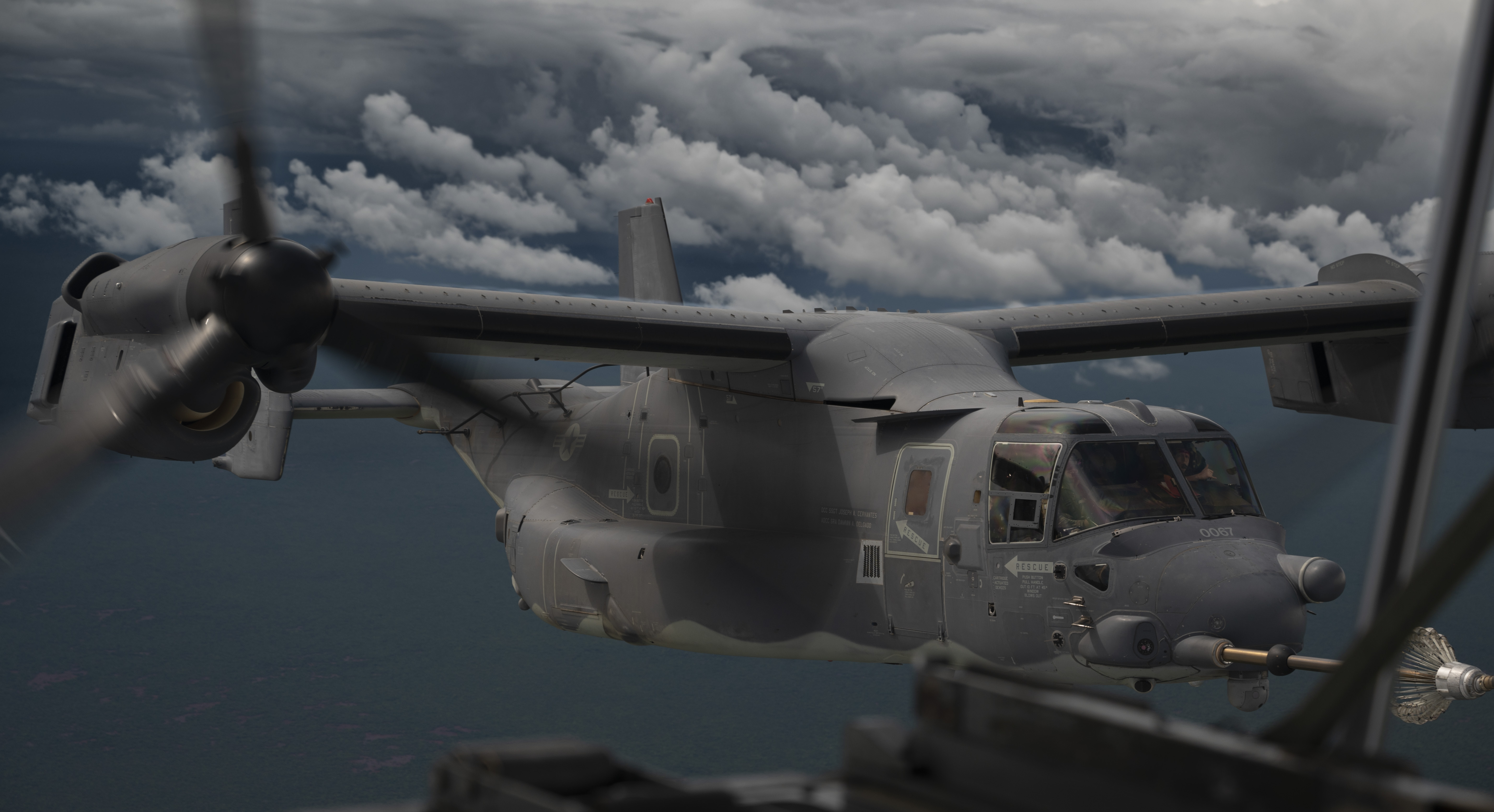A U.S. Air Force CV-22B Osprey tiltrotor aircraft, assigned to the 81st Expeditionary Rescue Squadron, conducts tactical air refueling from a U.S. Marine Corps KC-130J Hercules over Eastern Africa, 1 Nov., 2023. The 81st ERQS is a rapidly deployable combat search and rescue force that can conduct transport of personnel and equipment during day or night operations in support of combat personnel recovery within Combined Joint Task Force – Horn of Africa area of responsibility. (U.S. Air Force photo by Staff Sgt. Edward Coddington)