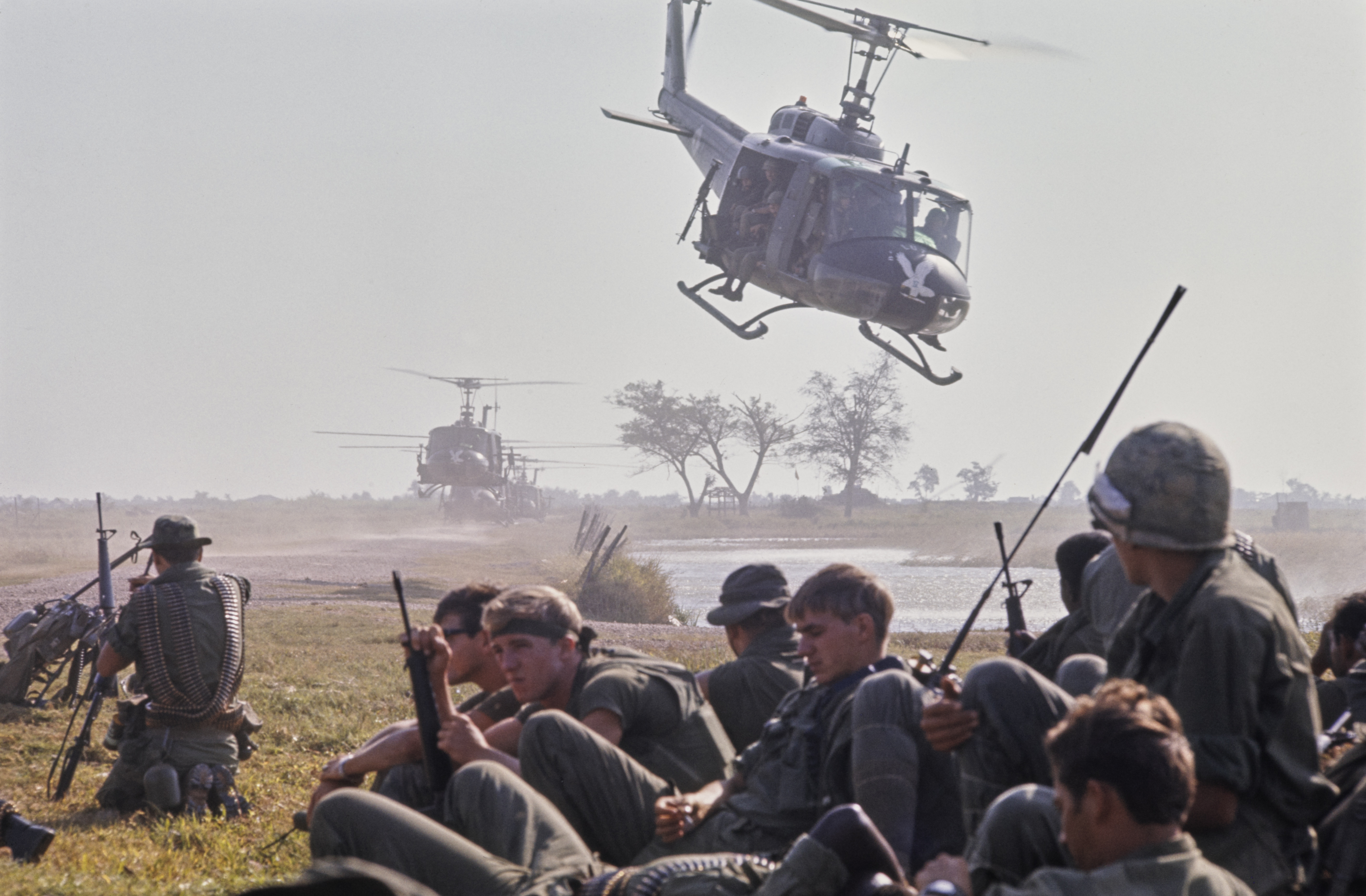 Soldiers of the United States Army 9th Infantry Division 3 Battalion waiting to board Bell UH-1 Iroquois helicopters as one takes off from the Plain of Reeds during routine delta operation in Tan An, South Vietnam, 23rd January 1970. (Photo by Bettmann Archive/Getty Images)