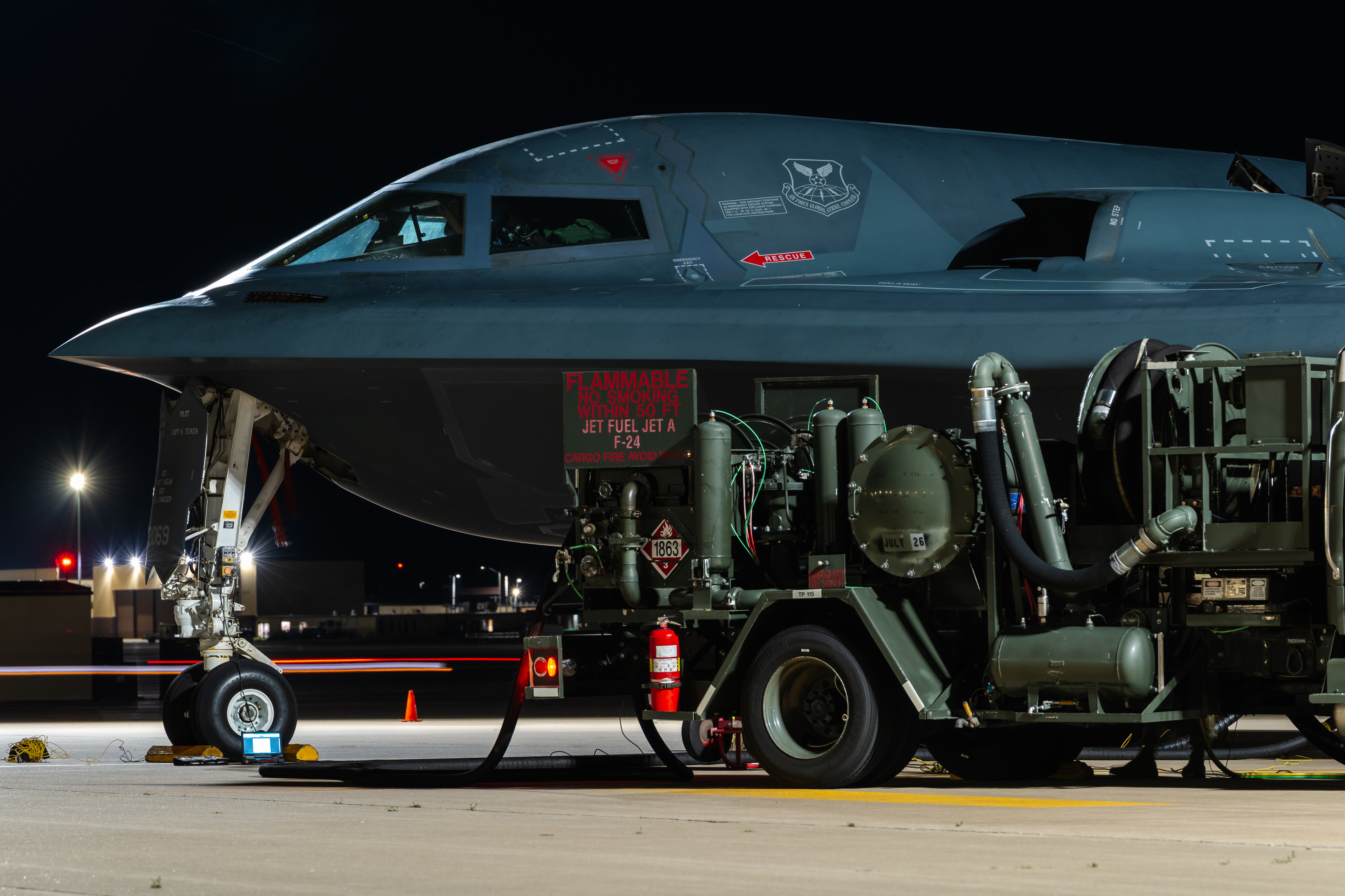 An R-12 hydrant service vehicle refuels a B-2 Spirit during hot-pit refueling operations at Whiteman Air Force Base, Mo., May 28, 2025. Hot-pit refueling is the practice of refueling an aircraft immediately after landing while keeping the engines running. (U.S. Air Force photo by Staff Sgt. Joshua Hastings)