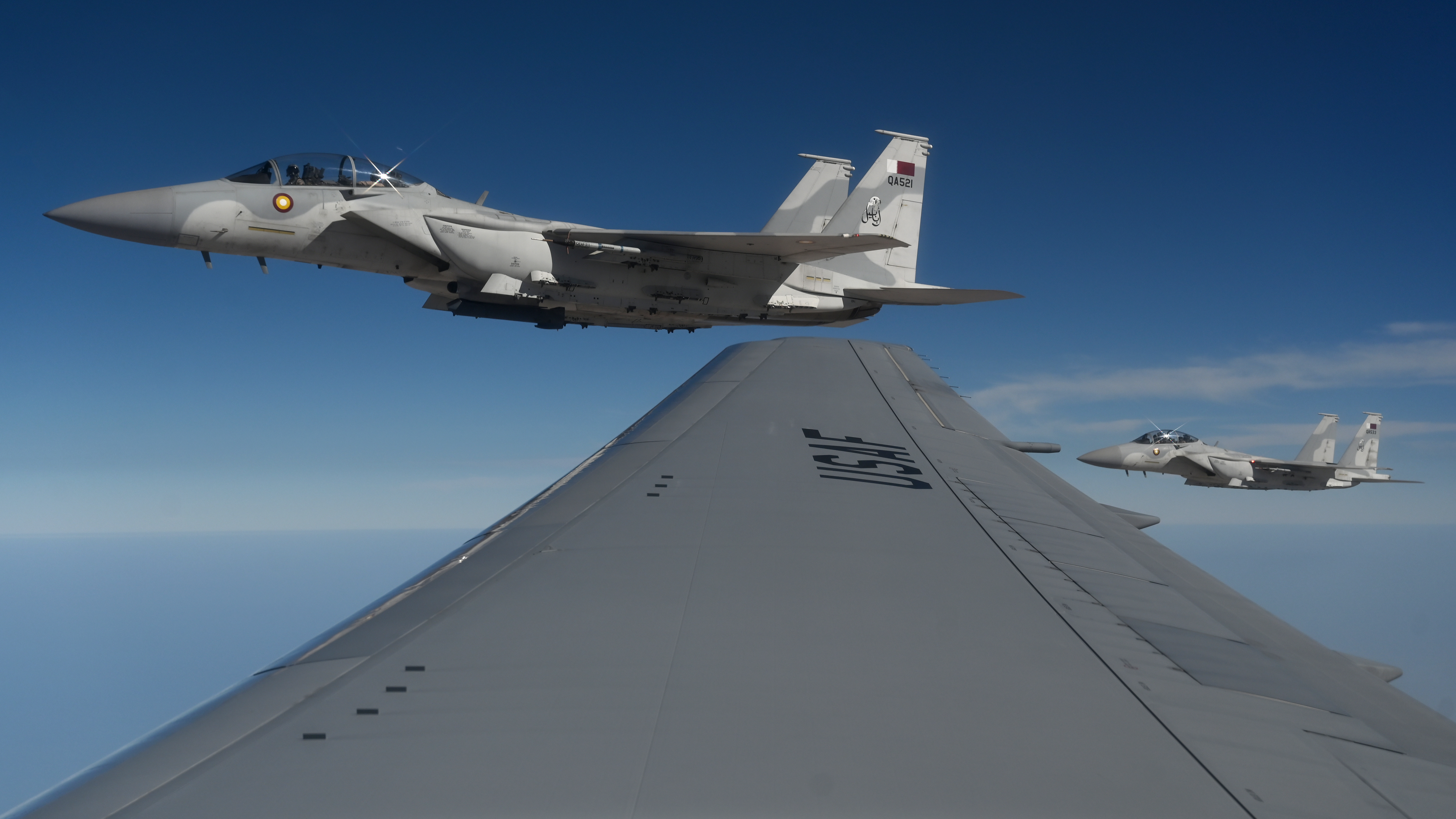 Two Qatar Emiri Air Force F-15QA Ababil fly in formation with a U.S. Air Force KC-46 Pegasus during Exercise Eagle Resolve 25 over Qatar, Jan. 21, 2025. This exercise demonstrates the U.S. commitment to deterrence and collective defense with Gulf Cooperation Council partners. (U.S. Air Force photo by Staff Sgt. Gerald R. Willis)