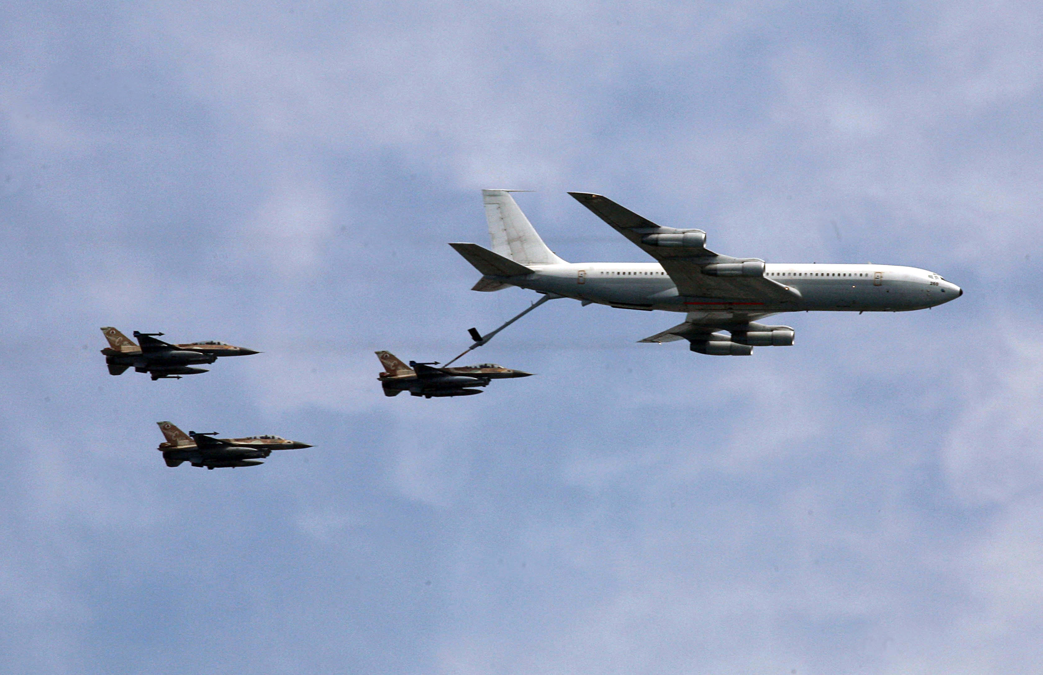 An Israeli plane KC-135 Stratotanker Boeing 707 refuels an F-16C Fighting Falcon during a military parade marking Israel's 60th anniversary on May 8, 2008 in Tel Aviv. Israel today threw a huge birthday bash to celebrate 60 tumultuous years during which the Jewish state made great strides forward but failed to achieve peace with its neighbours. AFP PHOTO/GALI TIBBON (Photo by GALI TIBBON / AFP) (Photo by GALI TIBBON/AFP via Getty Images)