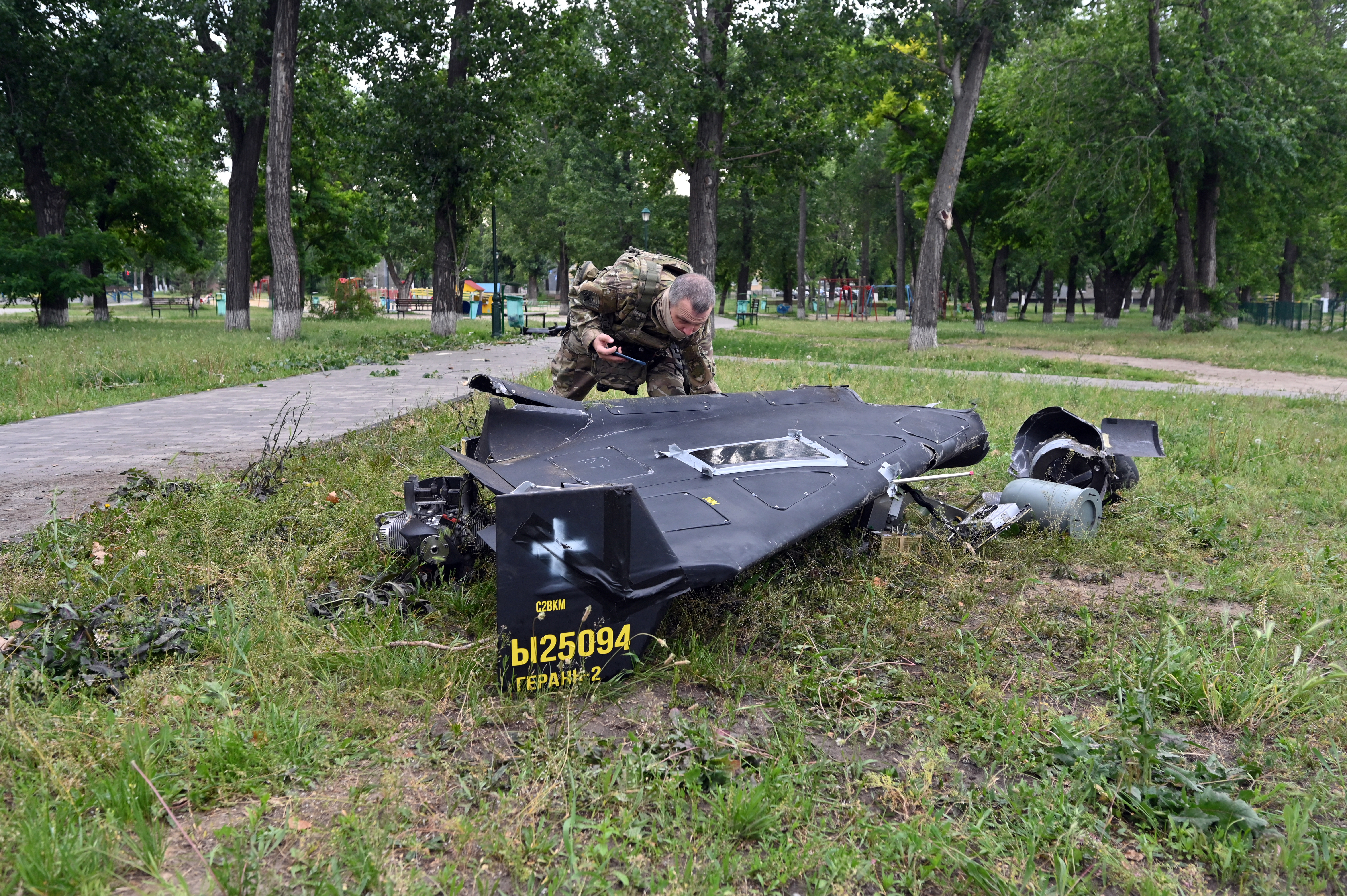 A Ukrainian explosives expert examines parts of a Shahed 136 military drone that fell down following an air-attack in Kharkiv on June 4, 2025, amid the Russian invasion of Ukraine. (Photo by SERGEY BOBOK / AFP) (Photo by SERGEY BOBOK/AFP via Getty Images)