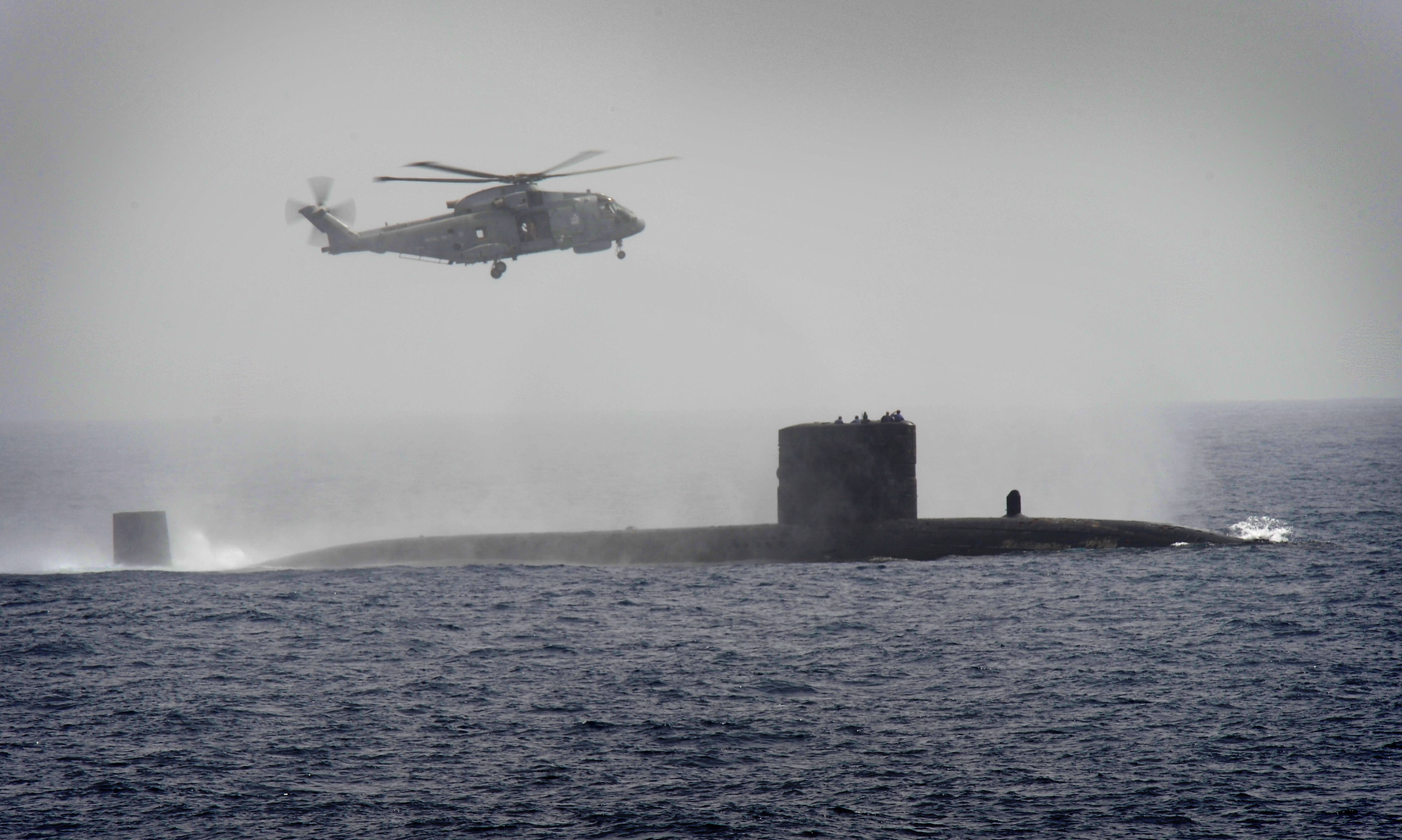 Trafalgar Class Fleet Submarine HMS Turbulent is pictured with the Merlin helicopter from Type 23 frigate HMS St Albans, during an anti-submarine exercise in the Gulf of Oman. The ship tested sonar ranges, radar ranges and lookouts during the exercise also involving HMS Turbulent and a small number of foreign vessels.
