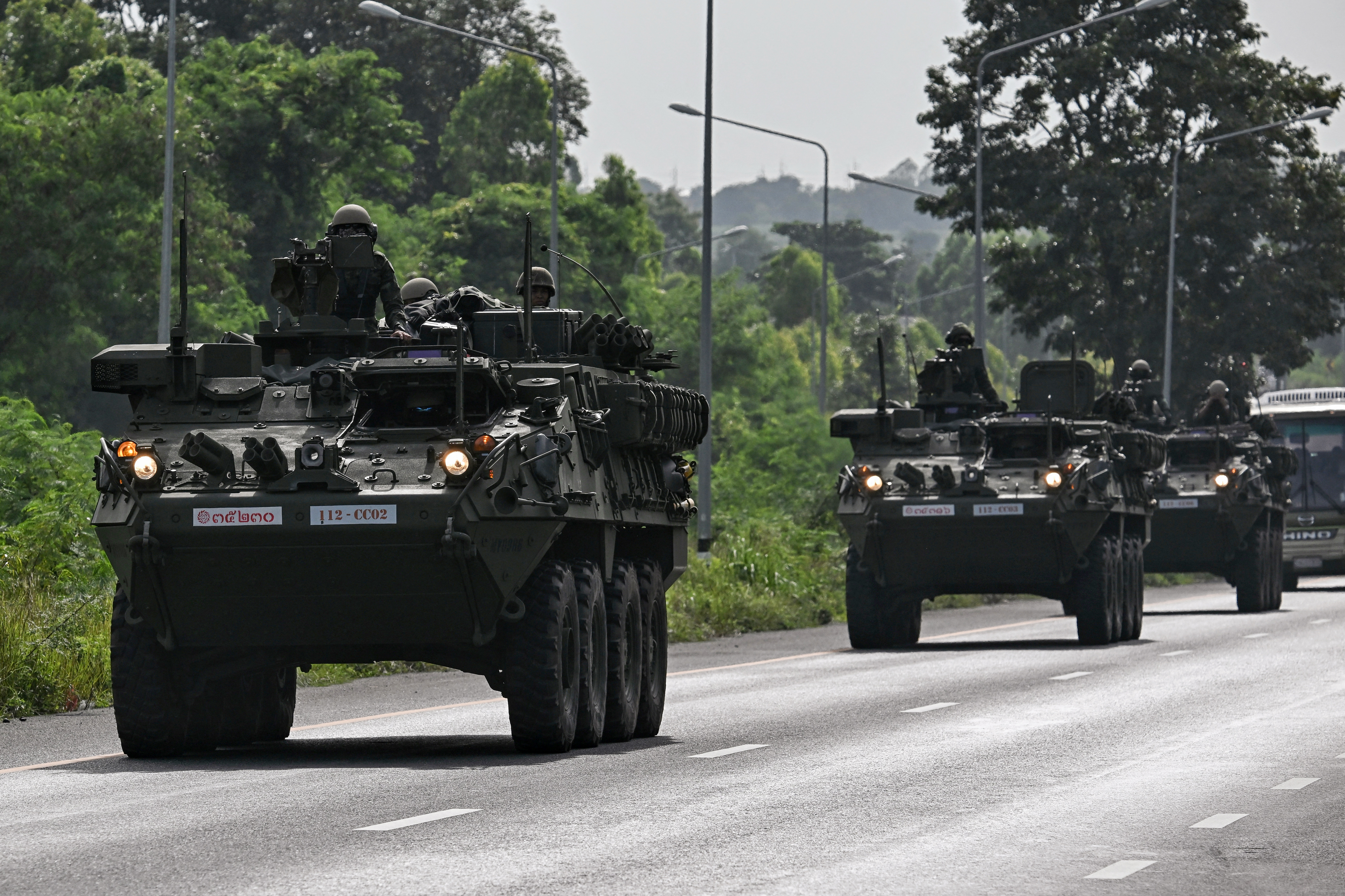 Royal Thai Army soldiers are pictured on armoured vehicles on a road in Chachoengsao province on July 24, 2025. Thailand launched air strikes on Cambodian military targets on July 24 as Cambodia fired rockets and artillery, killing at least 11 civilians, in a dramatic escalation of a long-running border row between the two neighbours. (Photo by Lillian SUWANRUMPHA / AFP) (Photo by LILLIAN SUWANRUMPHA/AFP via Getty Images)