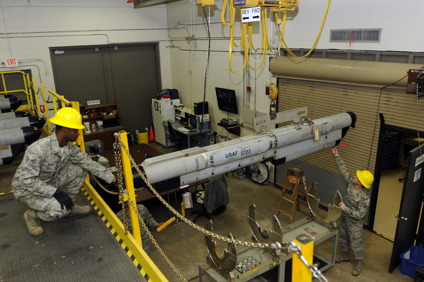 Senior Airman Steven Rucker and Staff Sgt. Justin Musall, electronic warfare technicians with 169th Maintenance Squadron’s Electronic Warfare shop at McEntire Joint National Guard Base, S.C., lowers an ALQ-184 electronic countermeasure pod from a lift to be moved to the testing equipment area for a 120-day Preventative Maintenance Inspection, Jan. 6, 2012. PMI’s are conducted every 120 and a major inspection at 320 days, where a specific series of tests are performed on various components at pre-set frequencies, ensuring the ECM pod is receiving and correctly responding to threat signals. Electronic warfare provides safety to our pilots and F-16’s in combat and training missions by providing total structural and electronic maintenance and repairs to the ALQ-184 ECM pod. The ALQ-184 is equipped with forward and aft antennas, which manipulates radiofrequency signals received and sends back false information, making it difficult for the enemy to lock a signal on our jets.