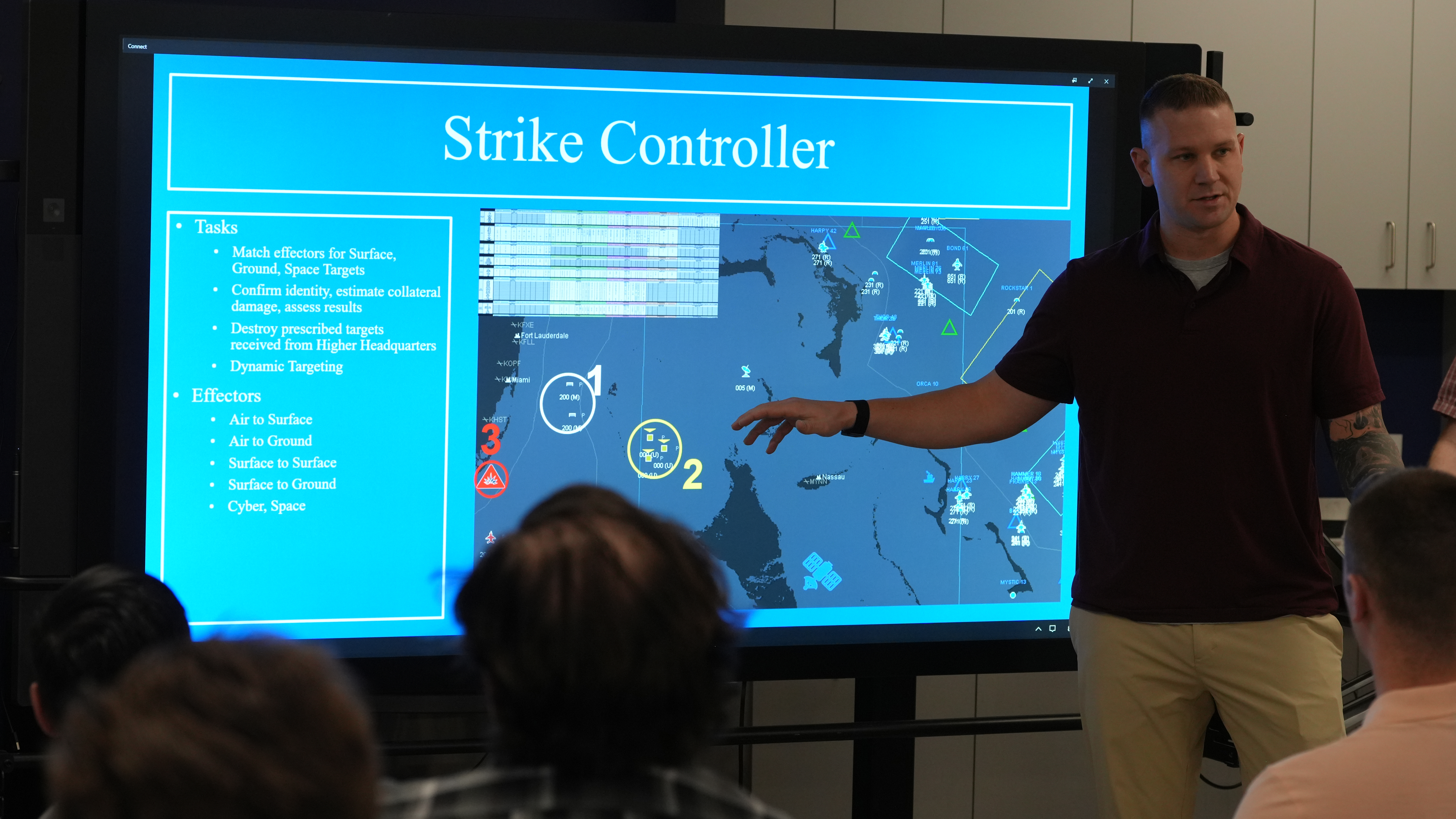 An Advanced Battle Management System Cross-Functional Team Capability Integration Airman briefs participating industry partners during the Department of the Air Forceâs second Decision Advantage Sprint for Human-Machine Teaming, or DASH, experiment, at the 805th Combat Training Squadronâs unclassified location in downtown Las Vegas, Nev., July 29, 2025. This two-week event brought together operational warfighters and industry and Shadow Operations Center-Nellis software developers to prototype microservices aimed at accelerating and improving decision-making in high-tempo battle management scenarios framed by the Transformational Model. (The image has been cropped to focus on the subjects.) (U.S. Air Force photo by Deb Henley)