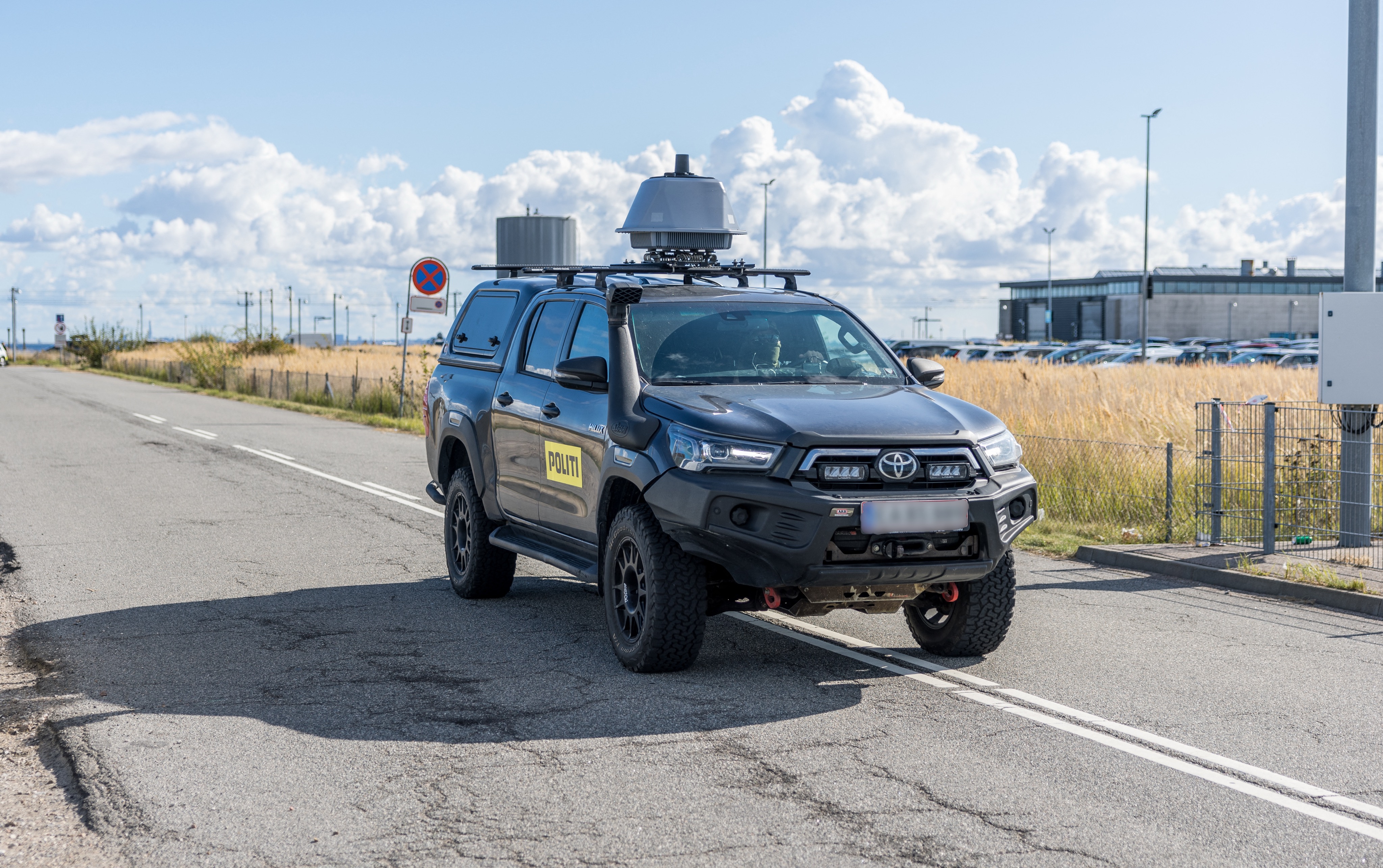 A police car is seen close to Copenhagen Airport on September 23, 2025. Large drones that flew over Copenhagen airport for hours and caused it to shut down constituted the "most serious attack on Danish critical infrastructure" to date, Prime Minister Mette Frederiksen said. Airports in Copenhagen and Oslo reopened early on September 23, hours after unidentified drones in their airspace caused dozens of flights to be diverted or cancelled, disrupting thousands of passengers. (Photo by Steven Knap / Ritzau Scanpix / AFP) / Denmark OUT (Photo by STEVEN KNAP/Ritzau Scanpix/AFP via Getty Images)