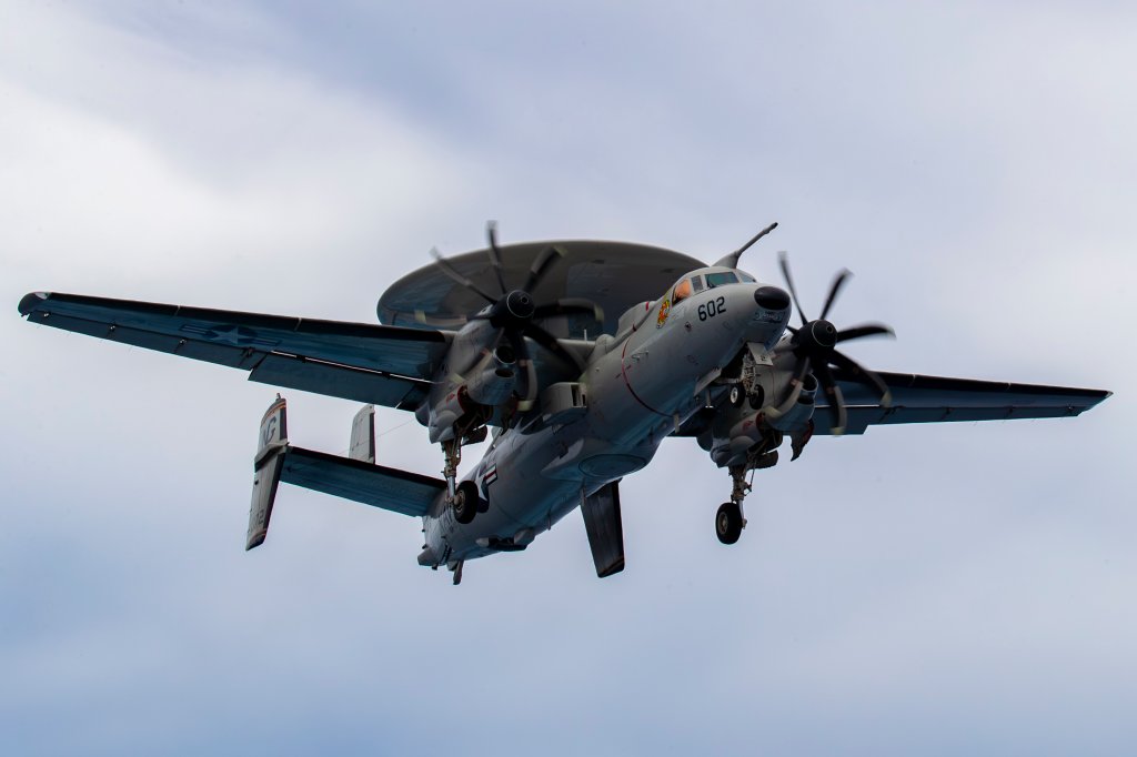 240801-N-NH911-1586 PACIFIC OCEAN (August 1, 2024) An E-2D Hawkeye, assigned to Airborne Command & Control Squadron (VAW) 117, flies over the Nimitz-class aircraft carrier USS Abraham Lincoln (CVN 72). Abraham Lincoln, flagship of Carrier Strike Group Three, is underway conducting routine operations in the U.S. 7th Fleet area of operations. U.S. 7th Fleet is the U.S. Navy’s largest forward-deployed numbered fleet, and routinely interacts and operates with allies and partners in preserving a free and open Indo-Pacific region. (U.S. Navy photo by Mass Communication Specialist Seaman Apprentice Daniel Kimmelman)