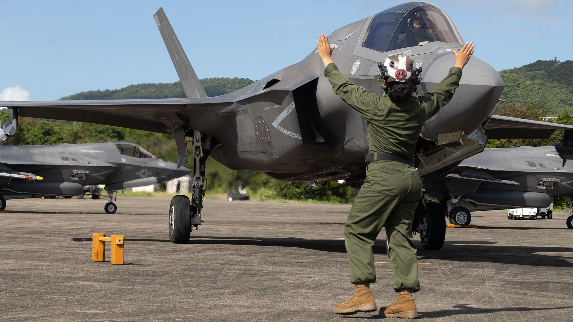 A U.S. Marine with Marine Fighter Attack Squadron 225, U.S. Marine Corps Forces, South, guides a U.S. Marine Corps F-35B Lightning II assigned to VMFA-225 after its landing at Jose Aponte de la Torre Airport, Puerto Rico, Sep. 22, 2025. U.S. military forces are deployed to the Caribbean in support of the U.S. Southern Command mission, Department of War-directed operations, and the president’s priorities. (U.S. Marine Corps photo by Lance Cpl. Michael Gavin)