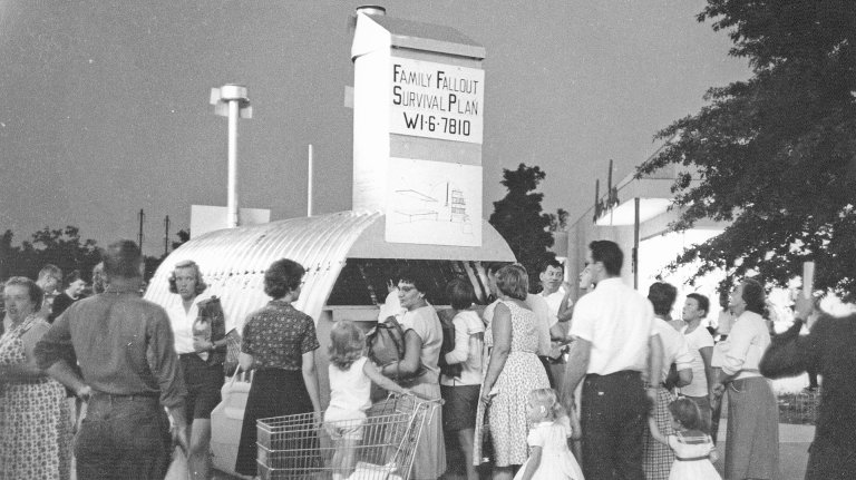 Outside Shop-A-Rama, also known as Levittown Shopping Center (and later as Levittown Town Center), potential customers inspect a demonstration fallout shelter, Levittown, Pennsylvania, June 1962. (Photo by Jack Rosen/Getty Images)