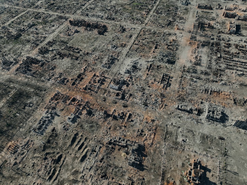 VOVCHANSK, UKRAINE - OCTOBER 2: An aerial view shows the destroyed city of Vovchansk in the Kharkiv Region near the border with Russia, on October 2, 2024 in Vovchansk, Ukraine. Russian artillery and aircraft have buildings used by soldiers of the Armed Forces of Ukraine. In September, Ukrainian forces recaptured the Volchansky chemical plant in Vovchansk, Kharkiv Oblast, a strategic location previously used by Russian troops for tactical operations along the Vovcha River. (Photo by Libkos/Getty Images)