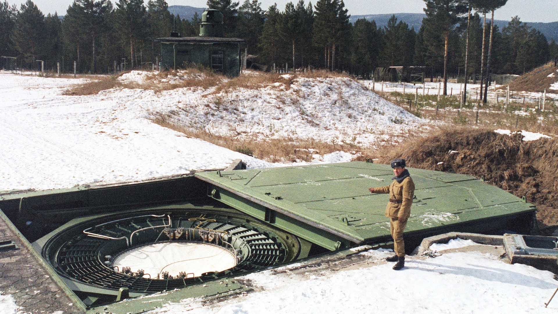 A Russian strategic nuclear forces (SNF) officer inspects a launching tube in the launching center of intercontinental ballistic missiles 20 March 1992 in Drovjanaja, near Cita, in Siberia. The strategic nuclear forces of the Russian Federation consist of ground intercontinental ballistic missiles (IBM) stationary, and also mobile, earth and railway variants of basing, sea and aviation strategic nuclear arms.