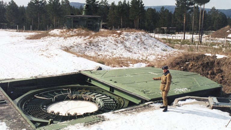 A Russian strategic nuclear forces (SNF) officer inspects a launching tube in the launching center of intercontinental ballistic missiles 20 March 1992 in Drovjanaja, near Cita, in Siberia. The strategic nuclear forces of the Russian Federation consist of ground intercontinental ballistic missiles (IBM) stationary, and also mobile, earth and railway variants of basing, sea and aviation strategic nuclear arms.