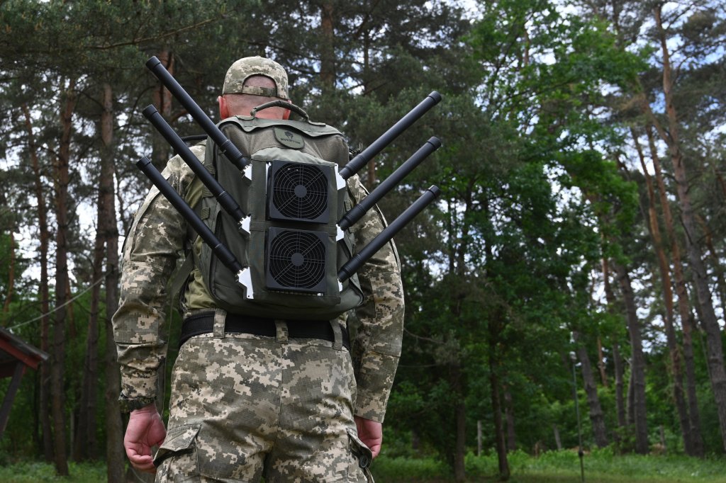 A Ukrainian serviceman tests an anti-drone backpack during a presentation of radio-electronic warfare (WB) and radio-electronic intelligence (PER) systems of the Ukrainian company Kvertus in Lviv region on May 28, 2024, amid the Russian invasion of Ukraine. The event was organized by the charity foundation 'Zavzhdy UA' (Forever Ukraine) with the Ukrainian company Kvertus. (Photo by YURIY DYACHYSHYN / AFP) (Photo by YURIY DYACHYSHYN/AFP via Getty Images)