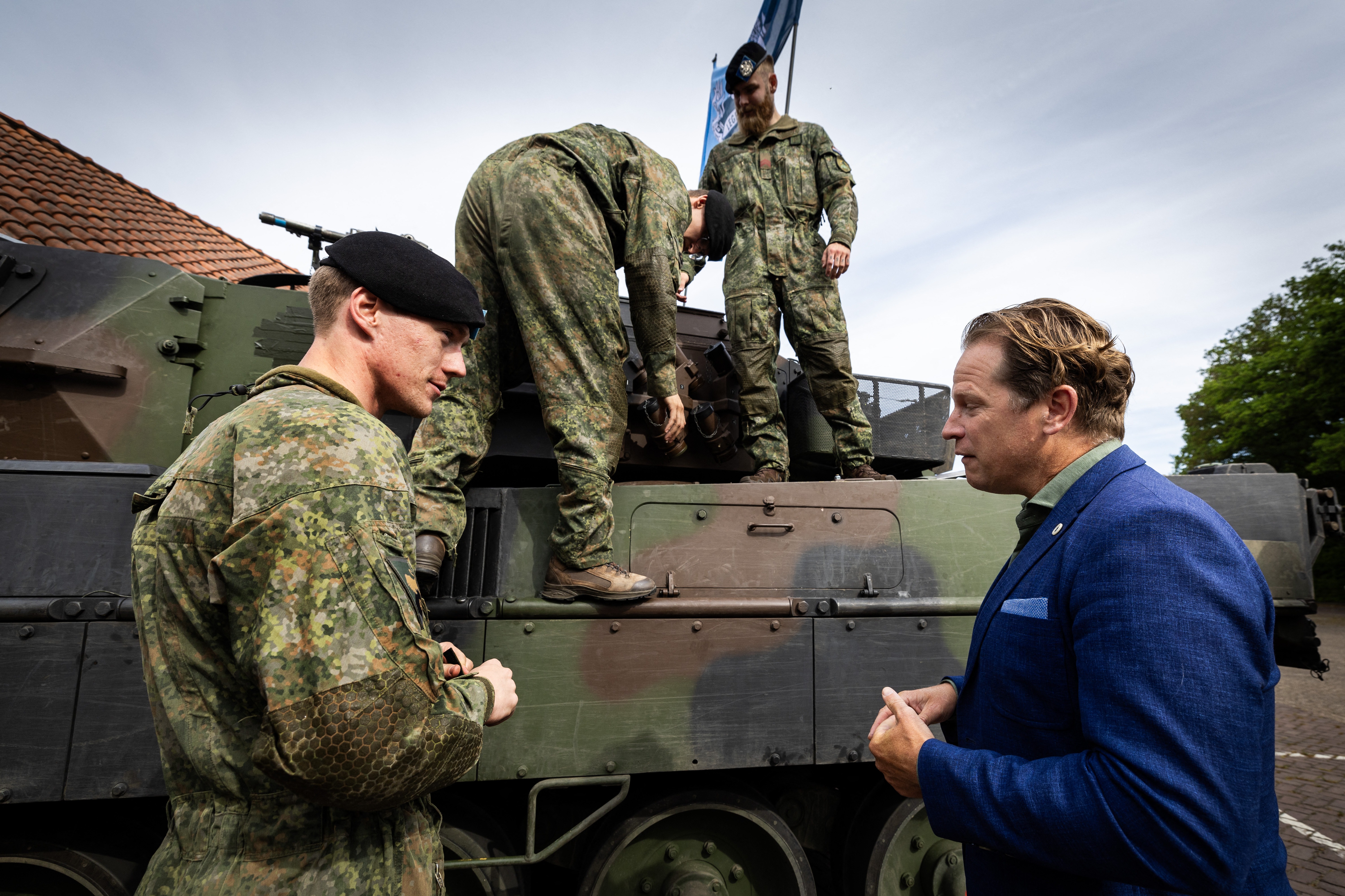 Netherlands' Defence minister Gijs Tuinman meets with soldiers of the Princess Catharina-Amalia Hussars Regiment by a leased German Leopard tank during a contract signing for new German made Leopard battle tanks in Amersfoort on May 14, 2025. (Photo by Vincent Jannink / ANP / AFP) / Netherlands OUT (Photo by VINCENT JANNINK/ANP/AFP via Getty Images)