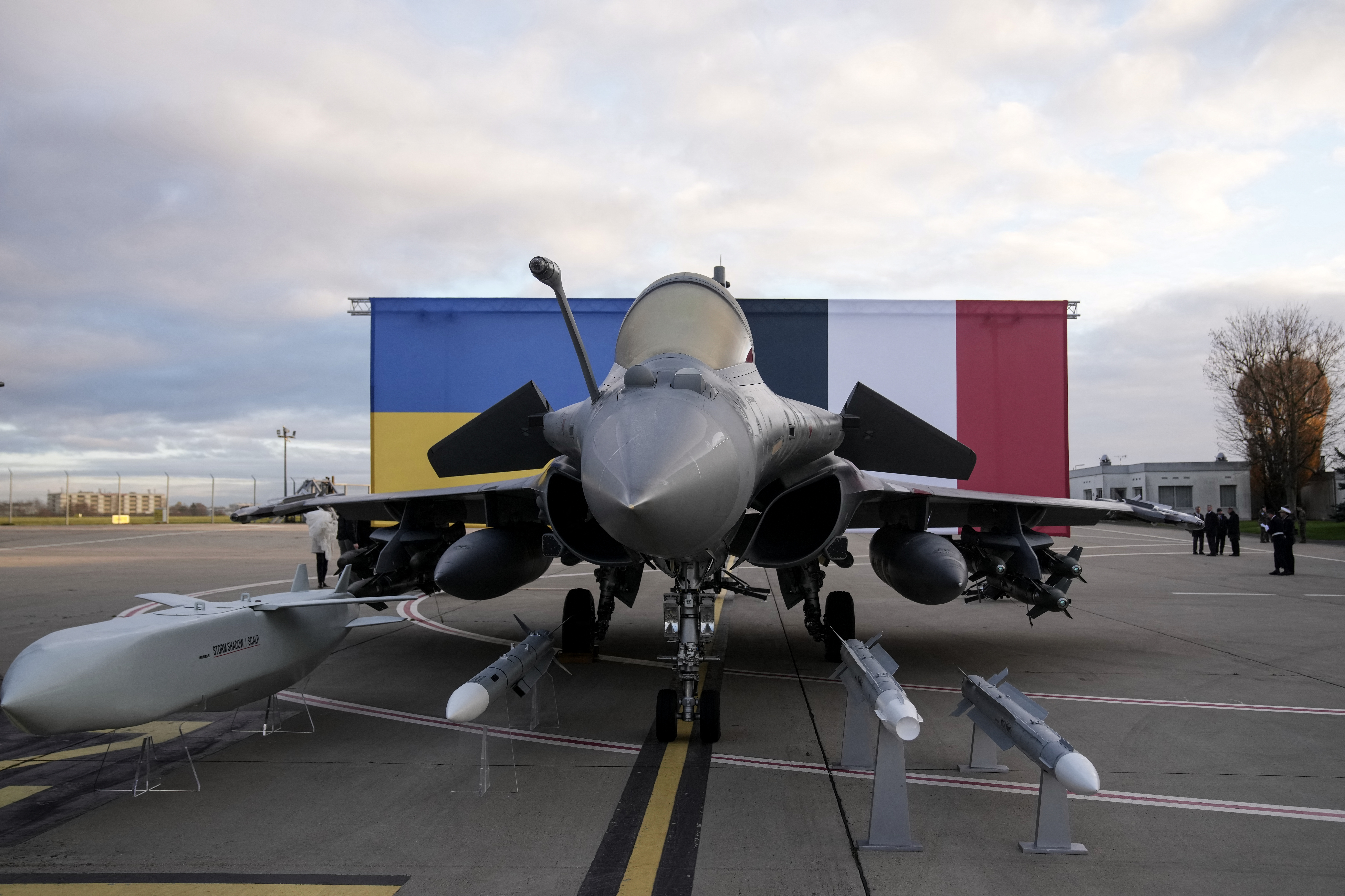 This photograph shows a Rafale jet fighter and a Storm Shadow (Scalp) missile with Ukraine's and France's national flags in the background before the arrival of Ukraine's President Volodymyr Zelensky at the Villacoublay air base, in Velizy-Villacoublay, near Paris on November 17, 2025. Ukraine's President visits Paris on November 17, 2025, in a new bid to secure weaponry to defend his country against increasingly lethal Russian missile and drone attacks. His visit is part of a brief tour of his western allies. (Photo by Christophe Ena / POOL / AFP) (Photo by CHRISTOPHE ENA/POOL/AFP via Getty Images)