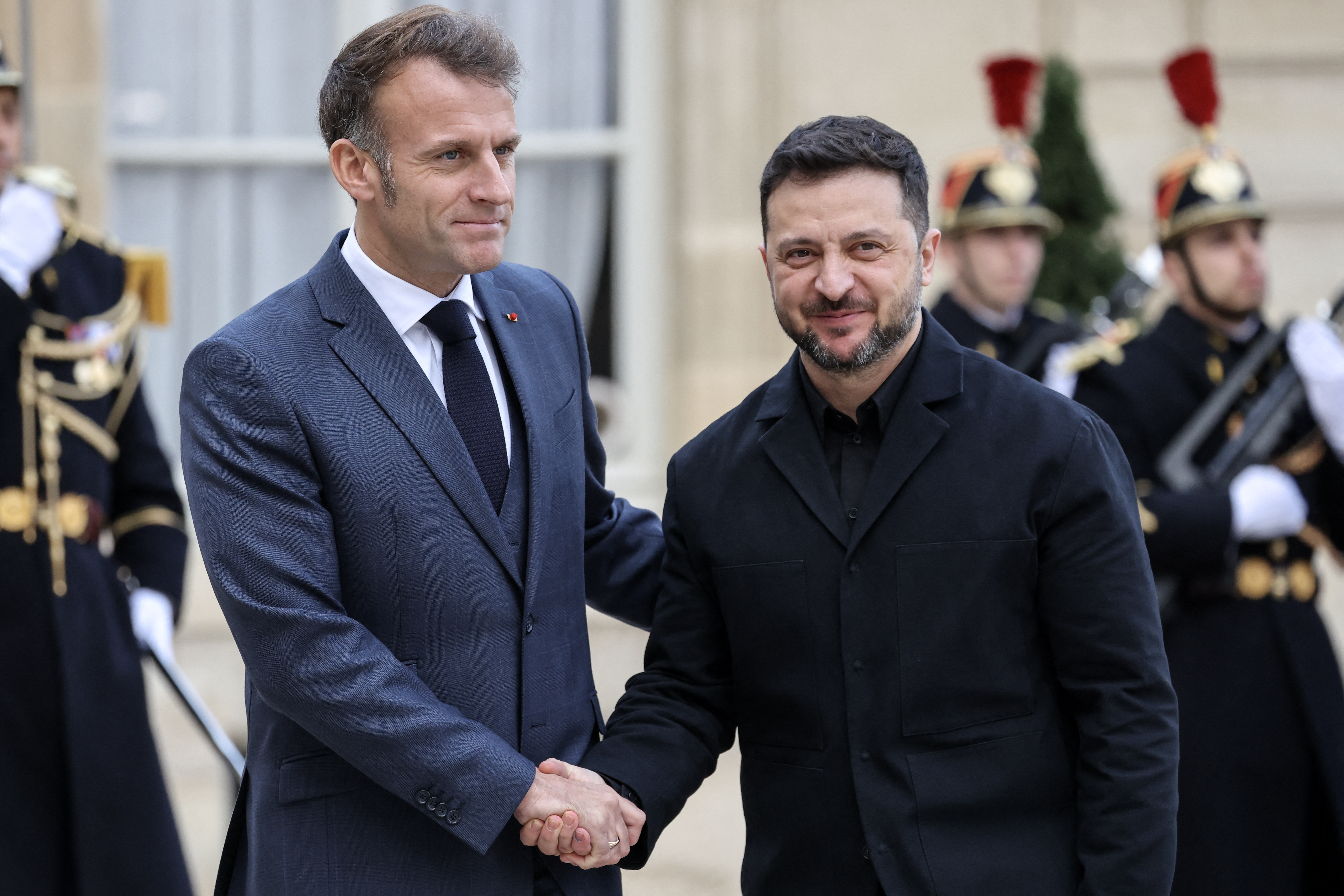 France's President Emmanuel Macron (L) welcomes Ukraine's President Volodymyr Zelensky before their meeting at the Elysee Palace in Paris on November 17, 2025. Macron and Zelensky signed a letter of intent for Kyiv to acquire up to 100 Rafale fighter jets and other air defence hardware from French companies, the French presidency said. (Photo by Ludovic MARIN / AFP) (Photo by LUDOVIC MARIN/AFP via Getty Images)