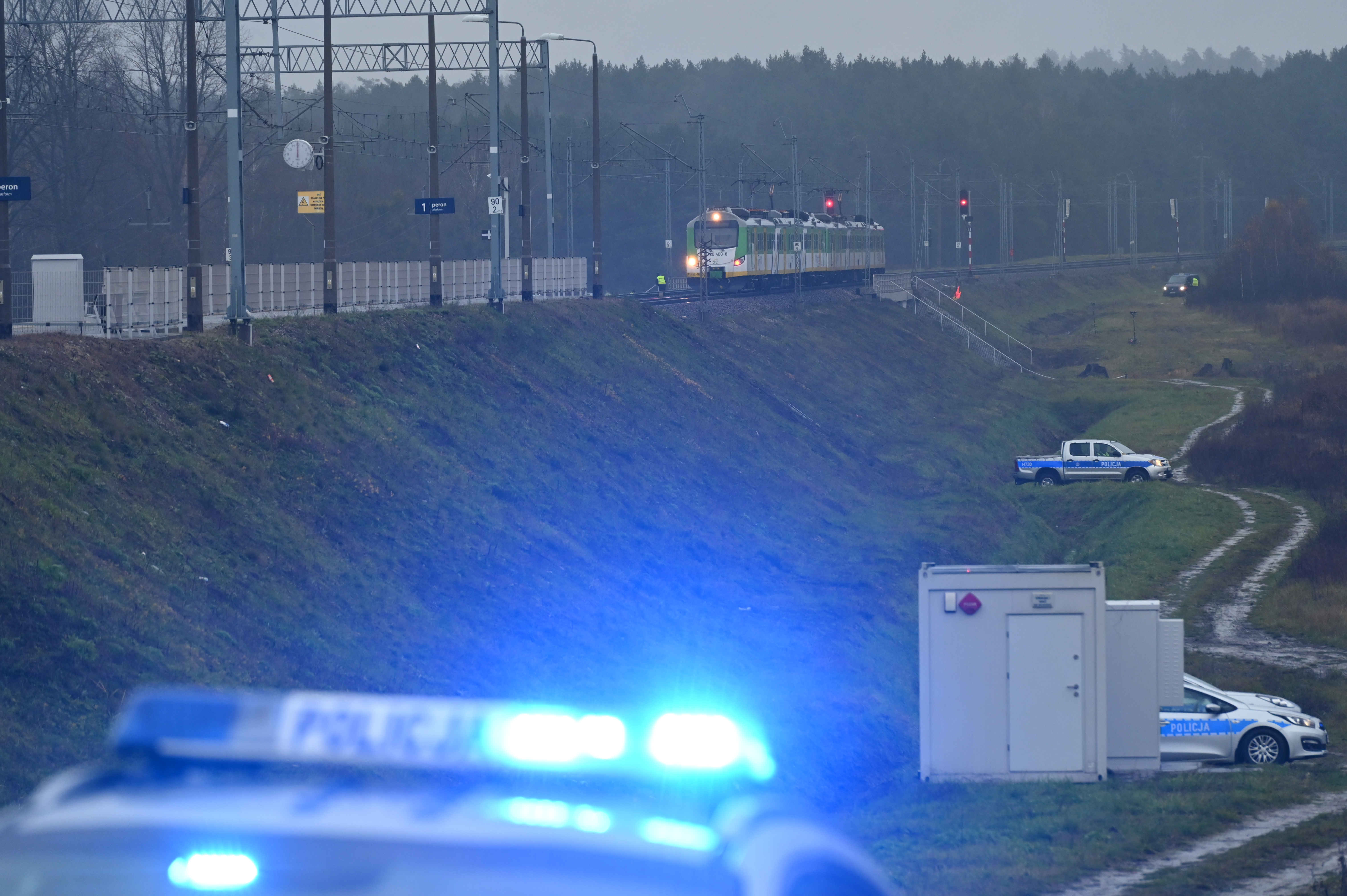Police investigate at the scene of a damaged section of railway tracks on the Deblin-Warsaw route near the Mika railway station, next to the town of Zyczyn, central Poland, on November 17, 2025. Polish Prime Minister Donald Tusk says that an act of sabotage takes place, resulting in the destruction of the railway tracks by an explosive device. The damaged route is also crucial for delivering aid to Ukraine. (Photo by Aleksander Kalka/NurPhoto via Getty Images)