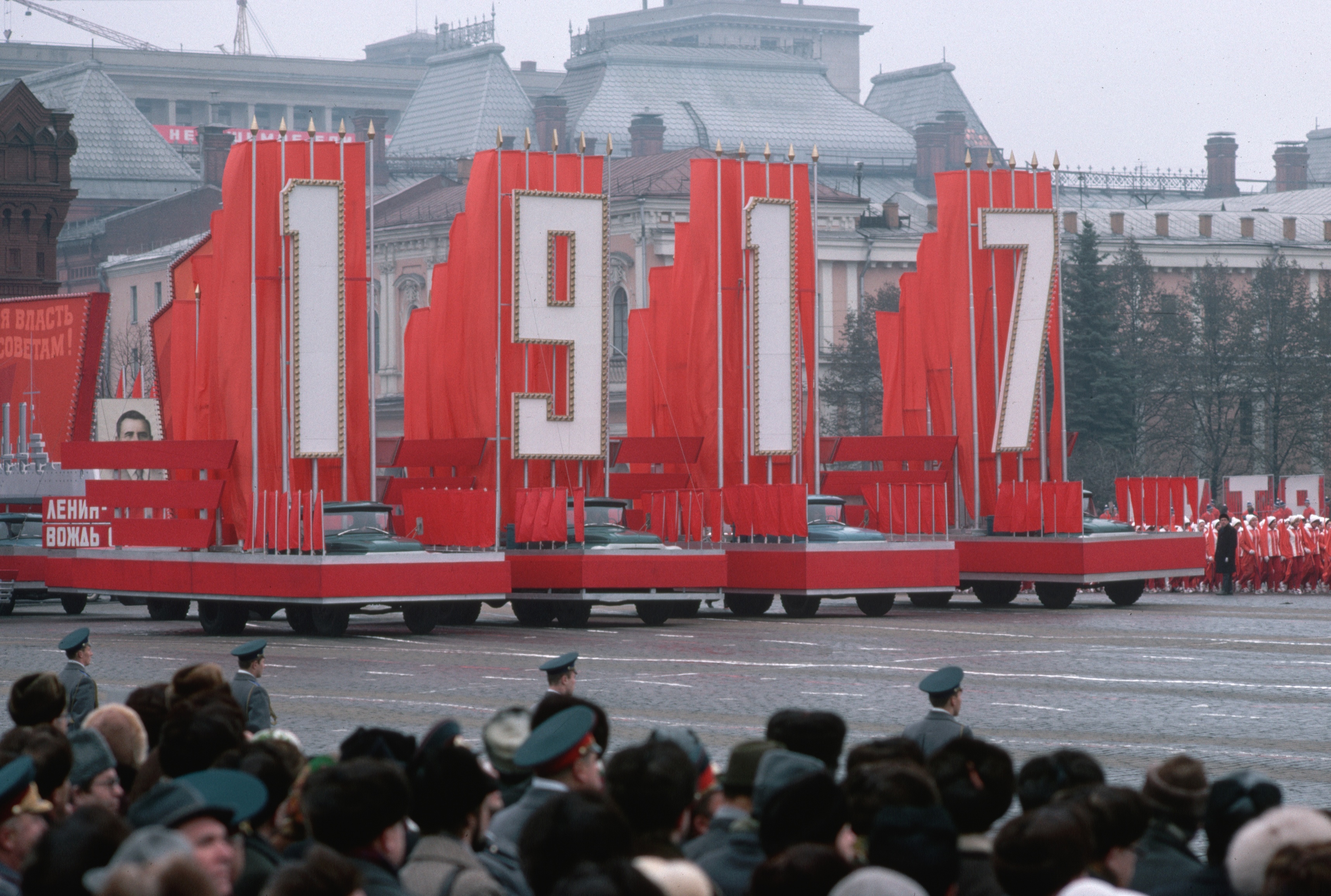 A procession of military floats, bearing large propaganda signs, moves slowly through Red Square during the 59th anniversary celebrations of the Bolsheviks' 1917 October Revolution. (Photo by �� Marc Garanger/CORBIS/Corbis via Getty Images)