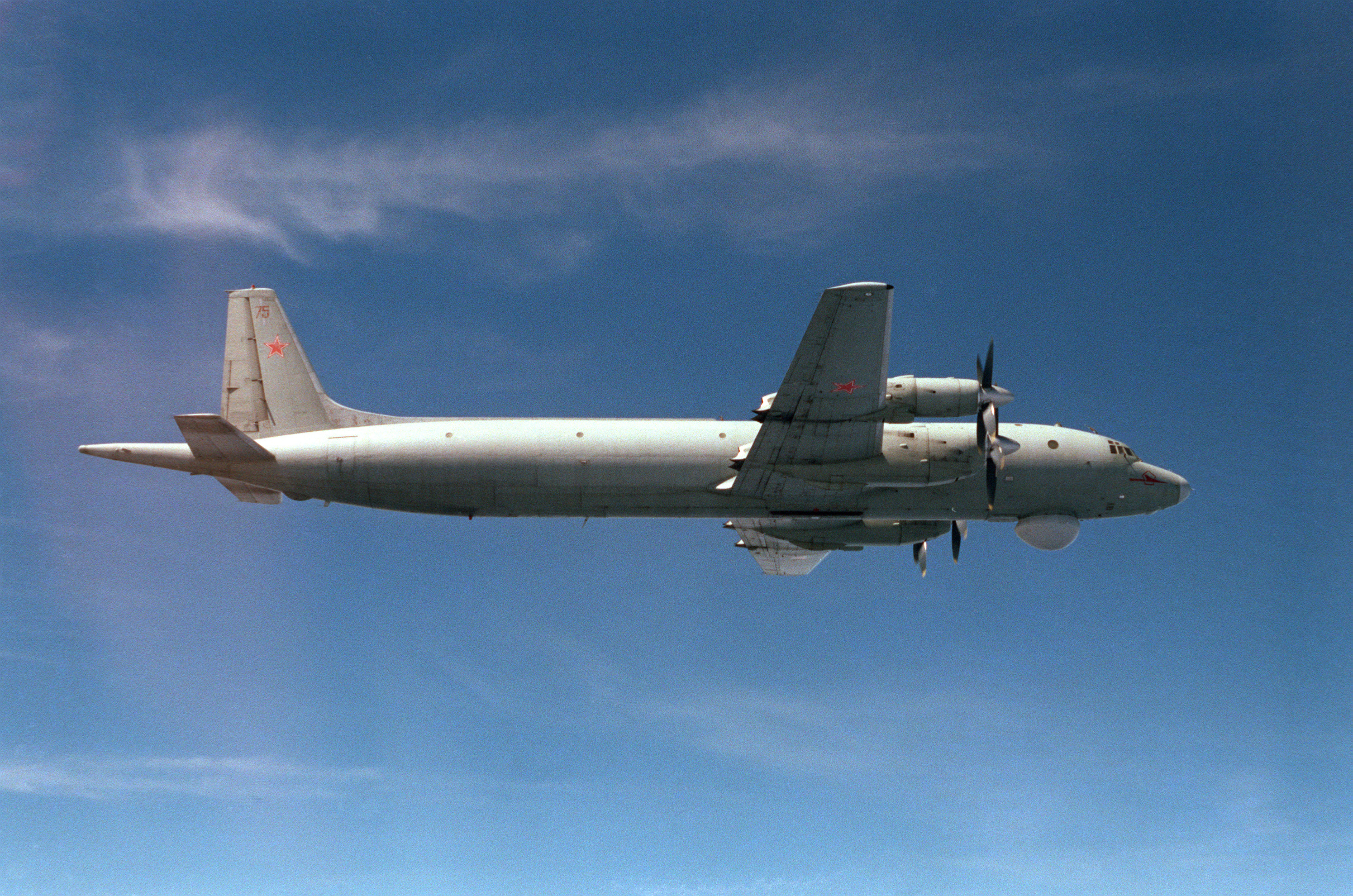 An air to air right side view of a Soviet IL-38 May aircraft.