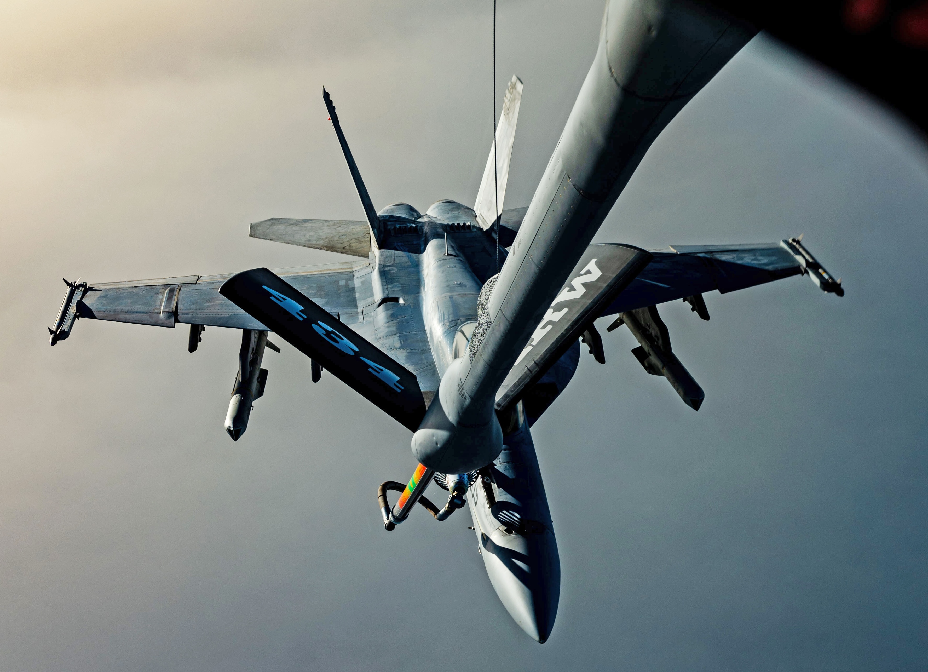 A U.S. Air Force KC-135 Stratotanker offloads fuel to a U.S. Navy F/A-18 Super Hornet, assigned to the Harry S. Truman Carrier Strike Group, over the U.S. Central Command area of responsibility, April 8, 2025. The KC-135 Stratotanker is the backbone of U.S. Air Forces Central's global reach aerial refueling capability and delivers critical support to joint and coalition aircraft in order to guarantee war-winning airpower throughout the CENTCOM AOR. (U.S. Air Force photo by Staff Sgt. Jackson Manske)