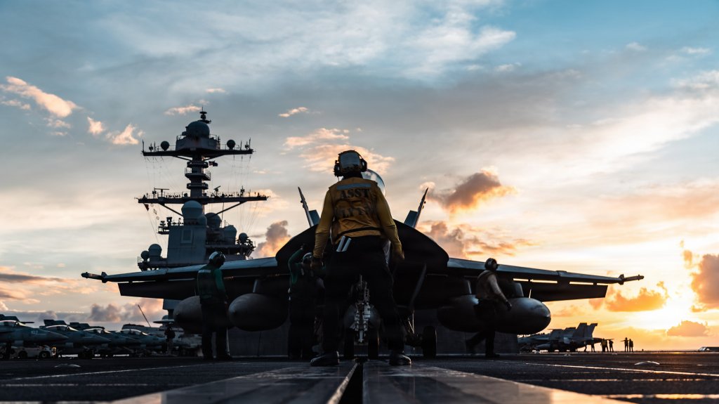 A U.S. Sailor directs an F/A-18F Super Hornet onto a catapult during flight operations aboard the world's largest aircraft carrier, Ford-class aircraft carrier USS Gerald R. Ford (CVN 78), while underway in the Caribbean Sea, Nov. 25, 2025. U.S. military forces are deployed to the Caribbean in support of Operation Southern Spear, the U.S. Southern Command mission, Department of War-directed operations, and the president’s priorities to disrupt illicit drug trafficking and protect the homeland. (U.S. Navy photo)