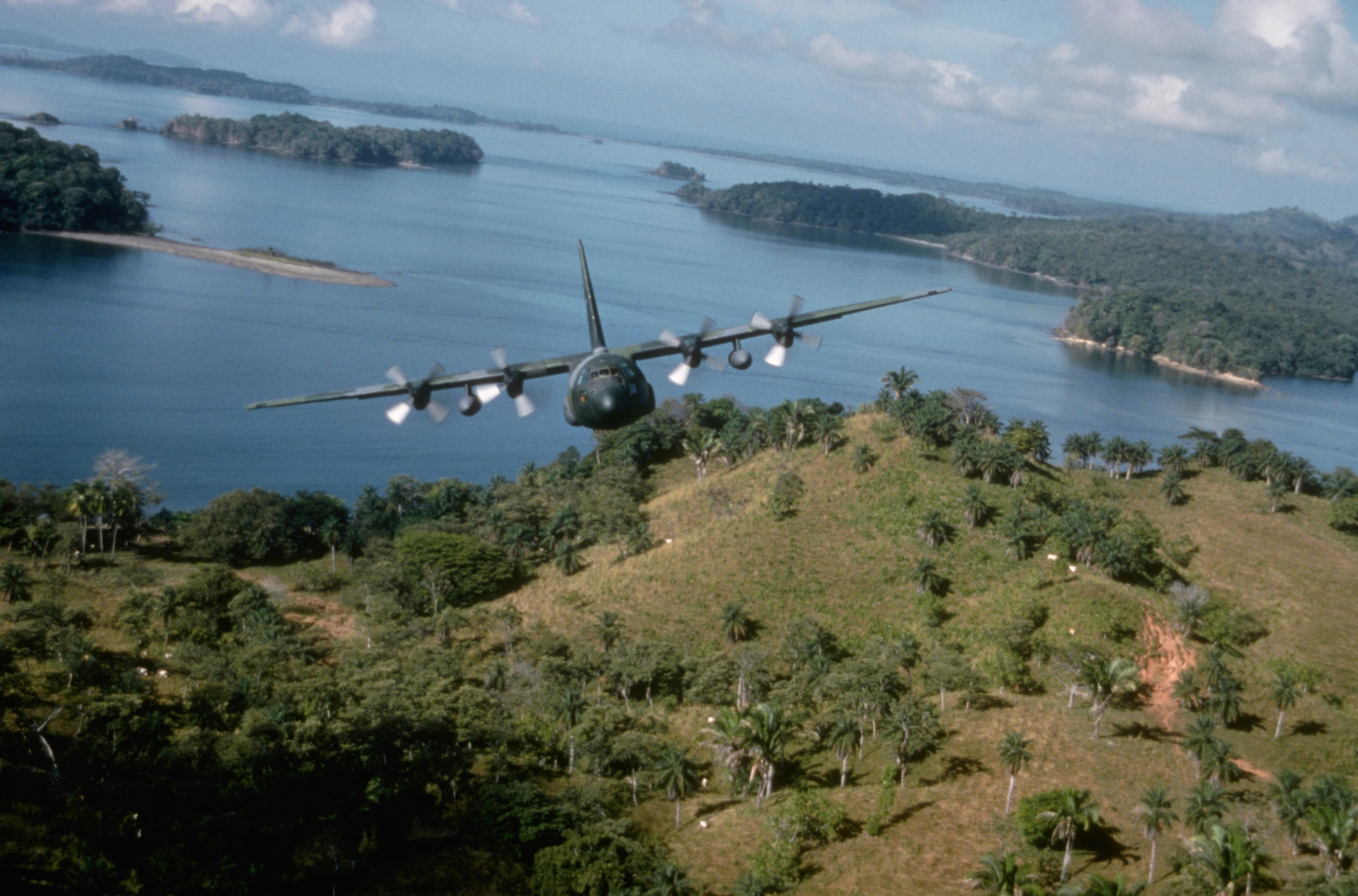 A C-130E Hercules aircraft from the 934th Tactical Airlift Group, U.S. Air Force Reserve, flies over the coast while returning to Howard Air Force Base, Panama, during Operation Just Cause. January 1990. (Photo by © CORBIS/Corbis via Getty Images)