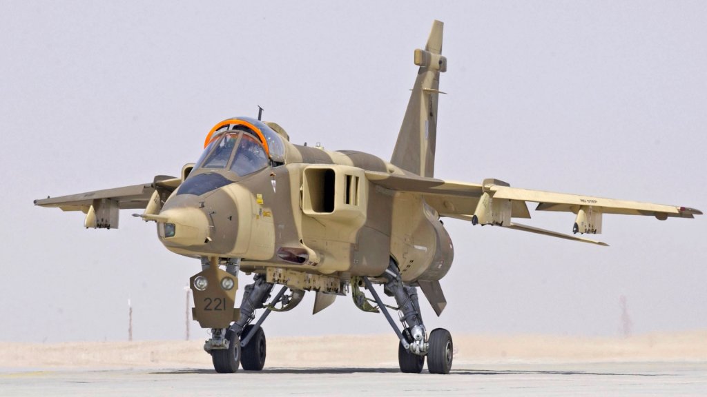A Royal Air Force of Oman Jaguar, taxies towards the runway at Thumrait, Oman. The aircraft was taking part in Exercise Magic Carpet 2005. The exercise was an opportunity for RN, RAF, Omani, French Air Force, USAF and USN squadrons to deploy and practice heavy-weapon bomb drops, utilising the extensive ranges and relatively clear airspace available over Oman. There were a variety of aircraft which took part, including our own Sea Harriers, GR7s and SKASaC, USN F18 and S3 Viking, USAF F16, French Mirage 2000 and RAF Tornado F3, Jaguar, VC10 air to air refuelling and E3D AWACS. In total around 60 aircraft were in theatre, allowing for realistic exercising of coalition forces. The participation of HMS Invincible with her Tailored Air Group (TAG) gave an excellent opportunity to prove the Strike Carrier concept within a controlled exercise environment and gain some useful general warfare training. It was a good opportunity for the ship's company to progress training in an exercise environment.