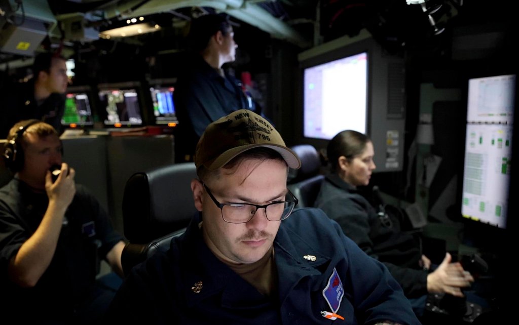ATLANTIC OCEAN (Oct. 30, 2024) – Sailors operate the helm console in the control room aboard the Virginia-class fast-attack submarine USS New Jersey (SSN 796) as the submarine transits the Atlantic Ocean. Fast-attack submarines are multi-mission platforms enabling five of the six Navy maritime strategy core capabilities – sea control, power projection, forward presence, maritime security and deterrence. They are designed to excel in anti-submarine warfare, anti-ship warfare, strike warfare, special operations, intelligence, surveillance and reconnaissance, irregular warfare and mine warfare. (Image produced utilizing a screen capture from video.) (U.S. Navy photo by Mass Communication Specialist 1st Class Justin E. Yarborough)