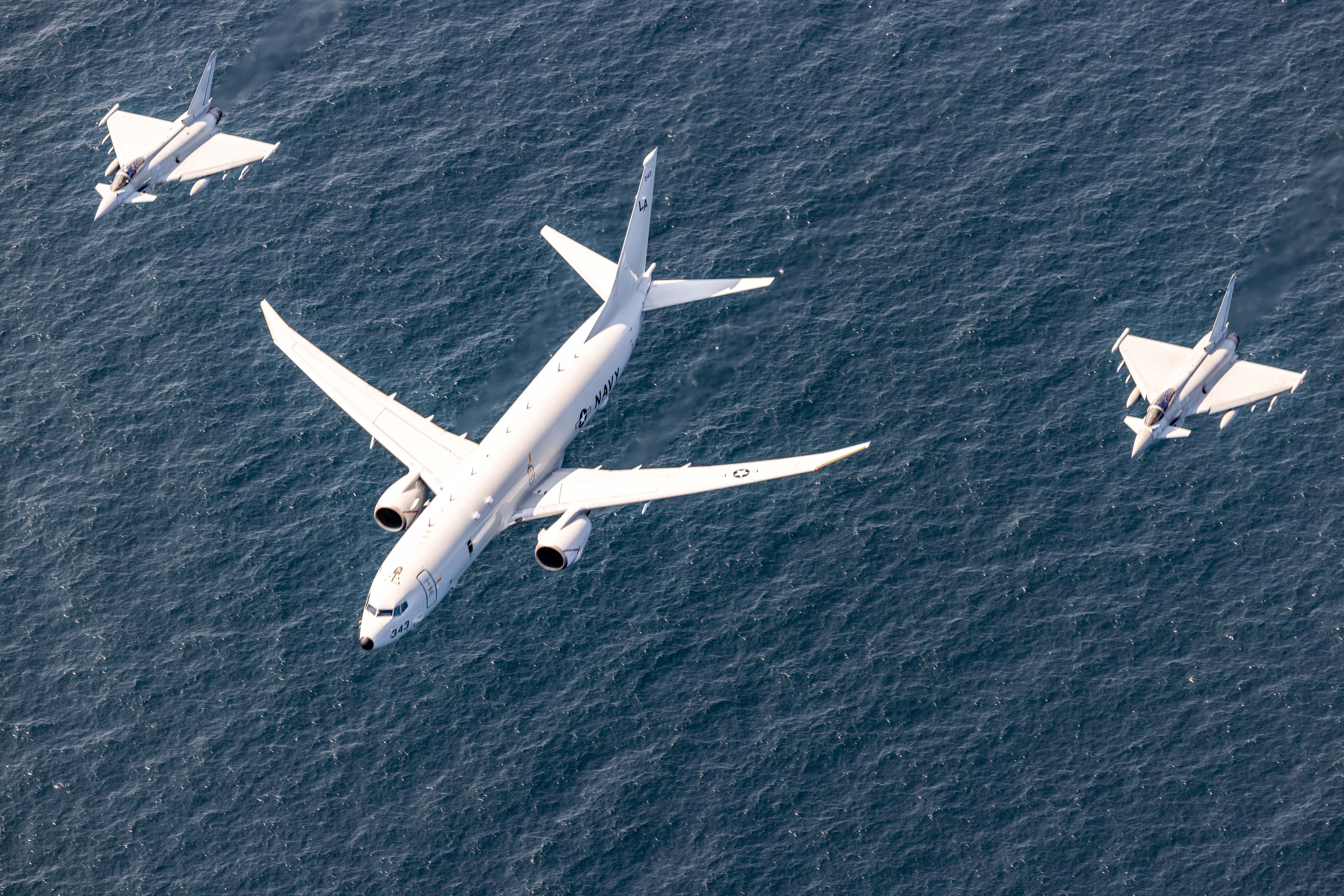 A U.S. Navy P-8A Poseidon, center, and two Royal Air Force Eurofighter Typhoon fighter aircraft participate in an aerial formation during exercise Baltic Operations 2025 (BALTOPS 25) in the Baltic Sea, June 12, 2025. BALTOPS 25, the premier maritime-focused exercise in the Baltic Region, provides a unique training opportunity to strengthen combined response capabilities critical to preserving freedom of navigation and security in the Baltic Sea. (U.S. Marine Corps photo by Lance Cpl. John Allen)