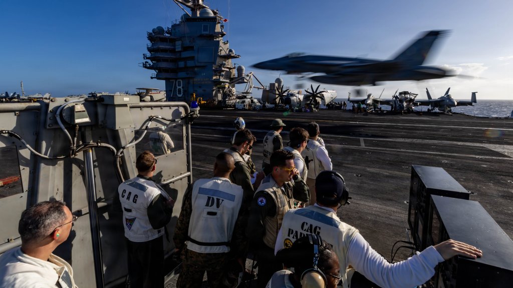 U.S. Sailors observe flight operations from the flight deck of the world’s largest aircraft carrier, Ford-class aircraft carrier USS Gerald R. Ford (CVN 78), while underway in the Caribbean Sea, Dec. 12, 2025. U.S. military forces are deployed to the Caribbean in support of the U.S. Southern Command mission, Department of War-directed operations, and the president’s priorities to disrupt illicit drug trafficking and protect the homeland. (U.S. Navy photo)