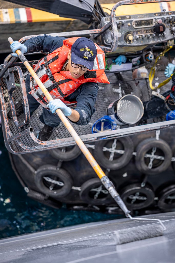U.S. Sailors, assigned to the Iwo Jima Amphibious Ready Group, paint the hull of Wasp-class amphibious assault ship USS Iwo Jima (LHD 7) while pierside in St. Croix, U.S. Virgin Islands, Dec. 15, 2025. U.S. military forces are deployed to the Caribbean in support of the U.S. Southern Command mission, Department of War-directed operations, and the president’s priorities to disrupt illicit drug trafficking and protect the homeland. (U.S. Navy photo)