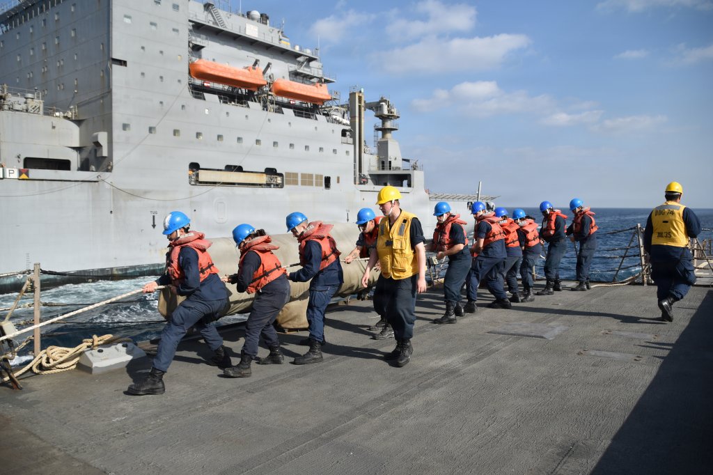 260103-N-HY958-8756 U.S. CENTRAL COMMAND AREA OF RESPONSIBILITY (Jan. 3, 2026) U.S. Sailors heave a line from the Lewis and Clark-class dry cargo ship USNS Carl Brashear (T-AKE-7) during a replenishment-at-sea aboard the Arleigh Burke-class guided-missile destroyer USS McFaul (DDG 74). McFaul is deployed to the U.S. 5th Fleet area of operations to support maritime security and stability in the U.S. Central Command area of responsibility. (U.S. Navy photo by Chief Intelligence Specialist Aubree Miller)