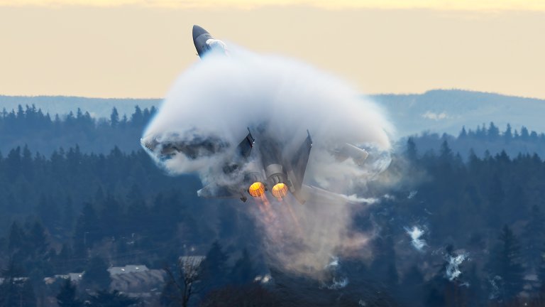 F-15EX from the 142nd fighter wing roars out of pDX in a huge vapor cloud as it climbs at the end of the runway.